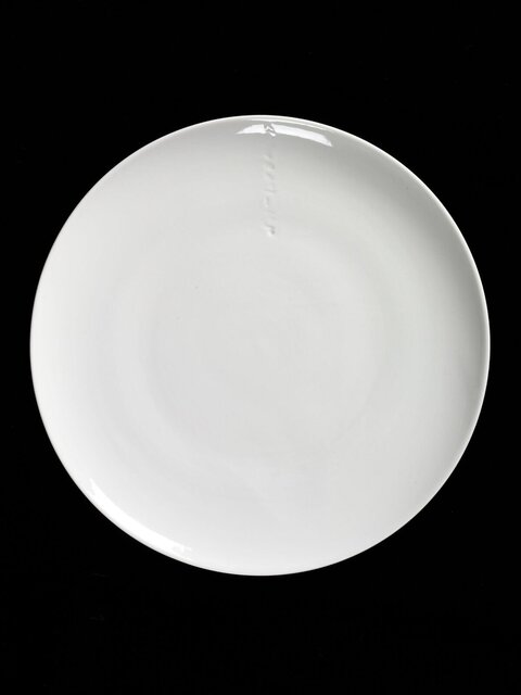 White Round Plate on Black Background