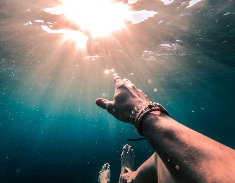 Underwater Hand Reaching for Sunlight