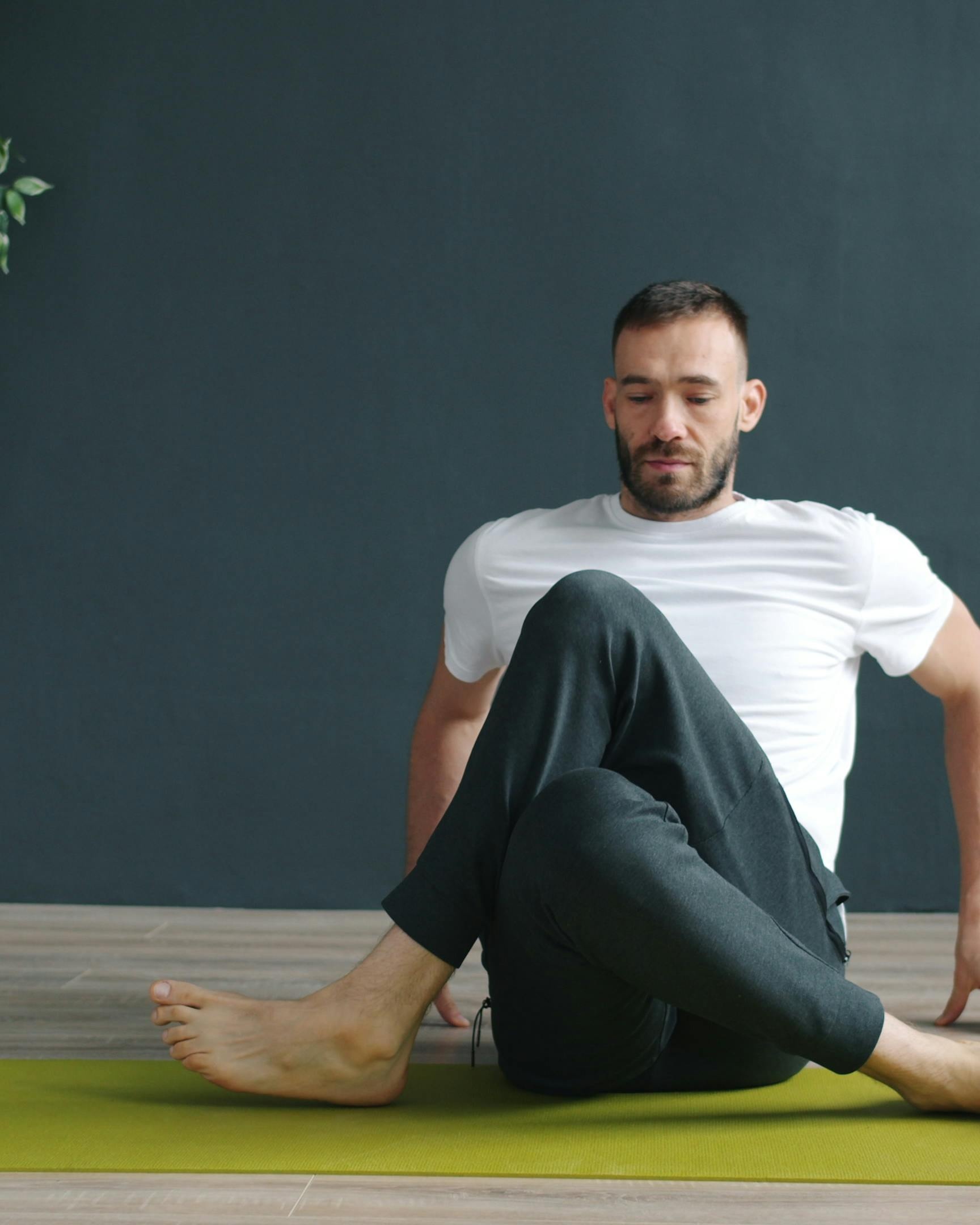 Man Practicing Yoga on Mat