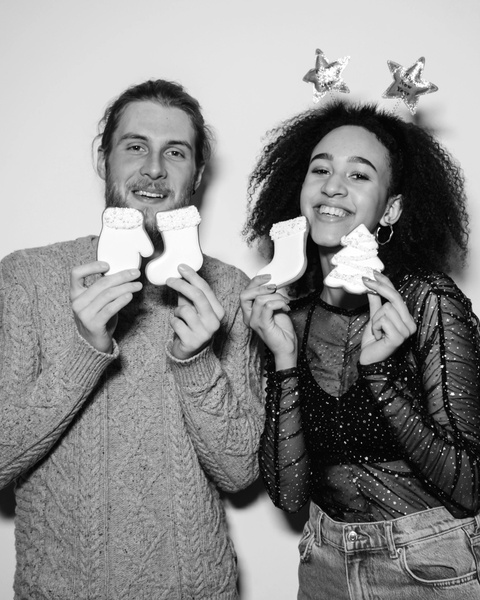 Smiling Couple With Holiday Christmas Cookies