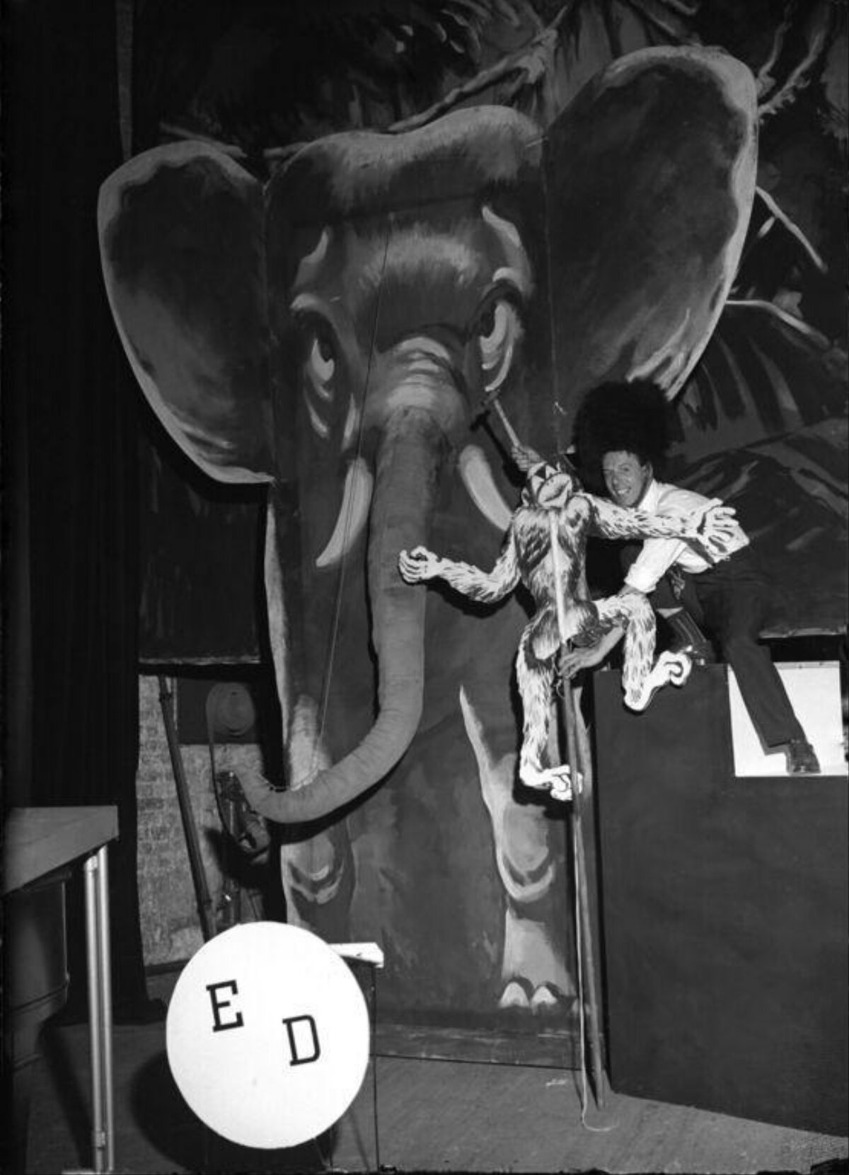 Stage Performer With Puppet and Painted Elephant
