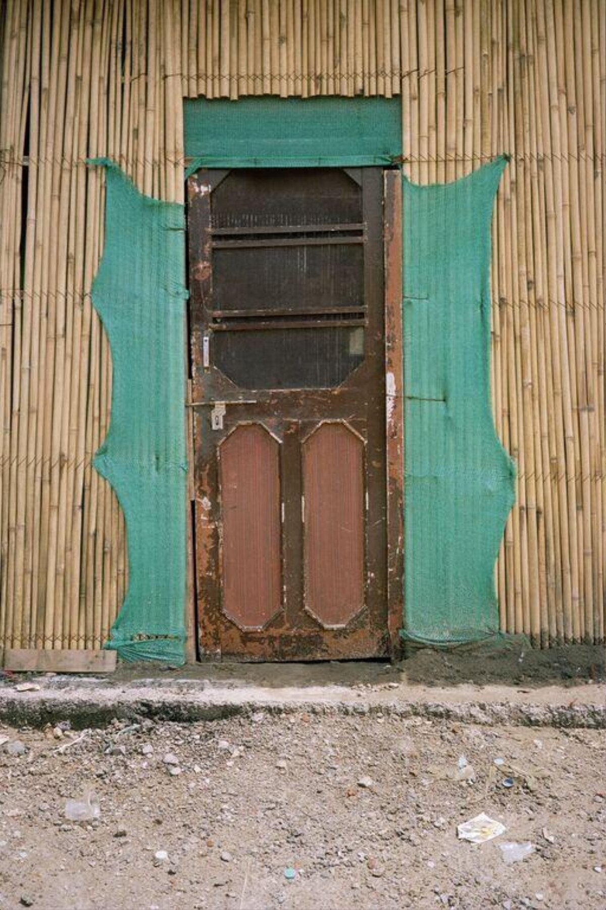 Old Door Against Bamboo Wall