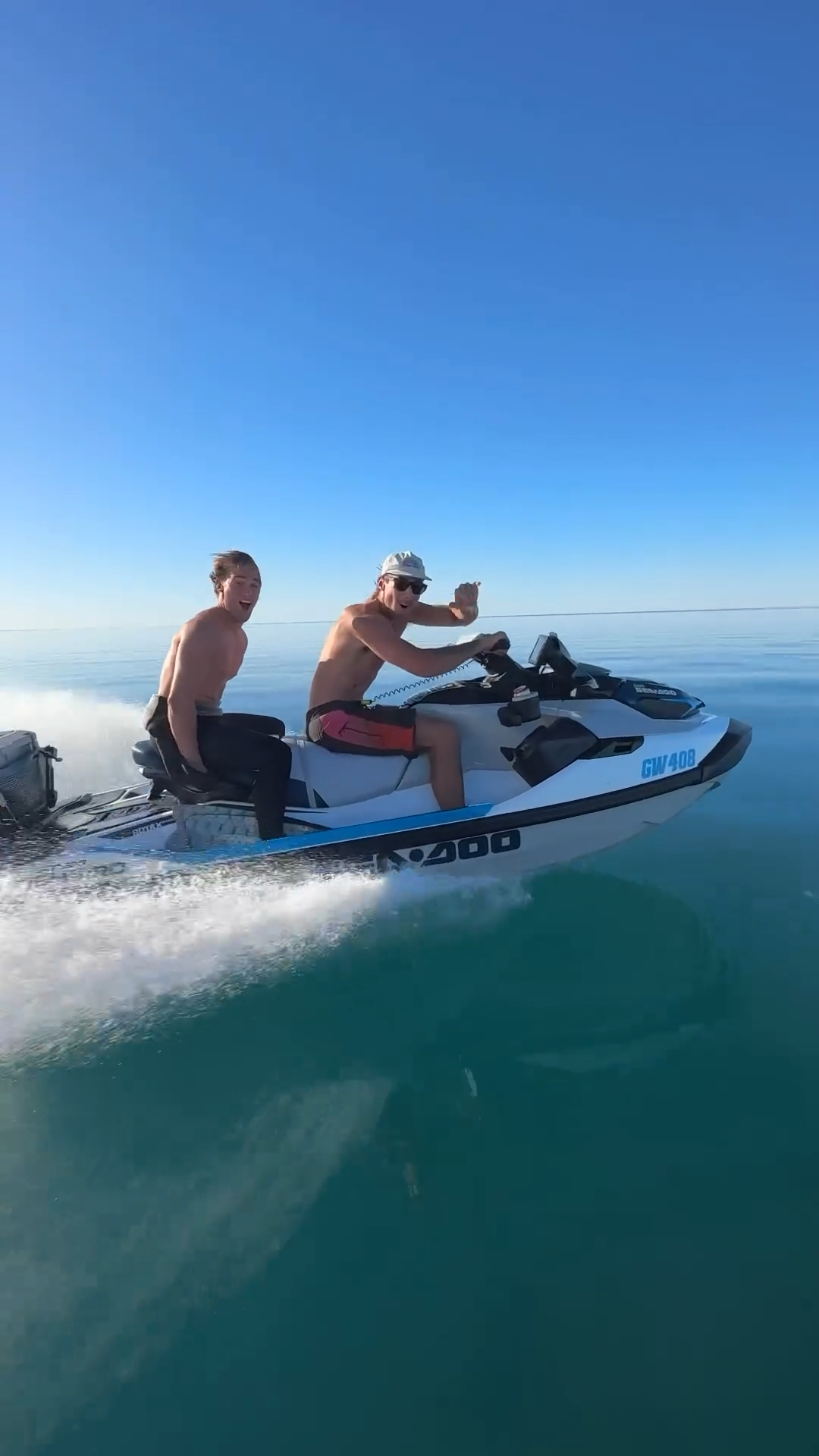 Two Men Riding Jet Ski on Open Sea