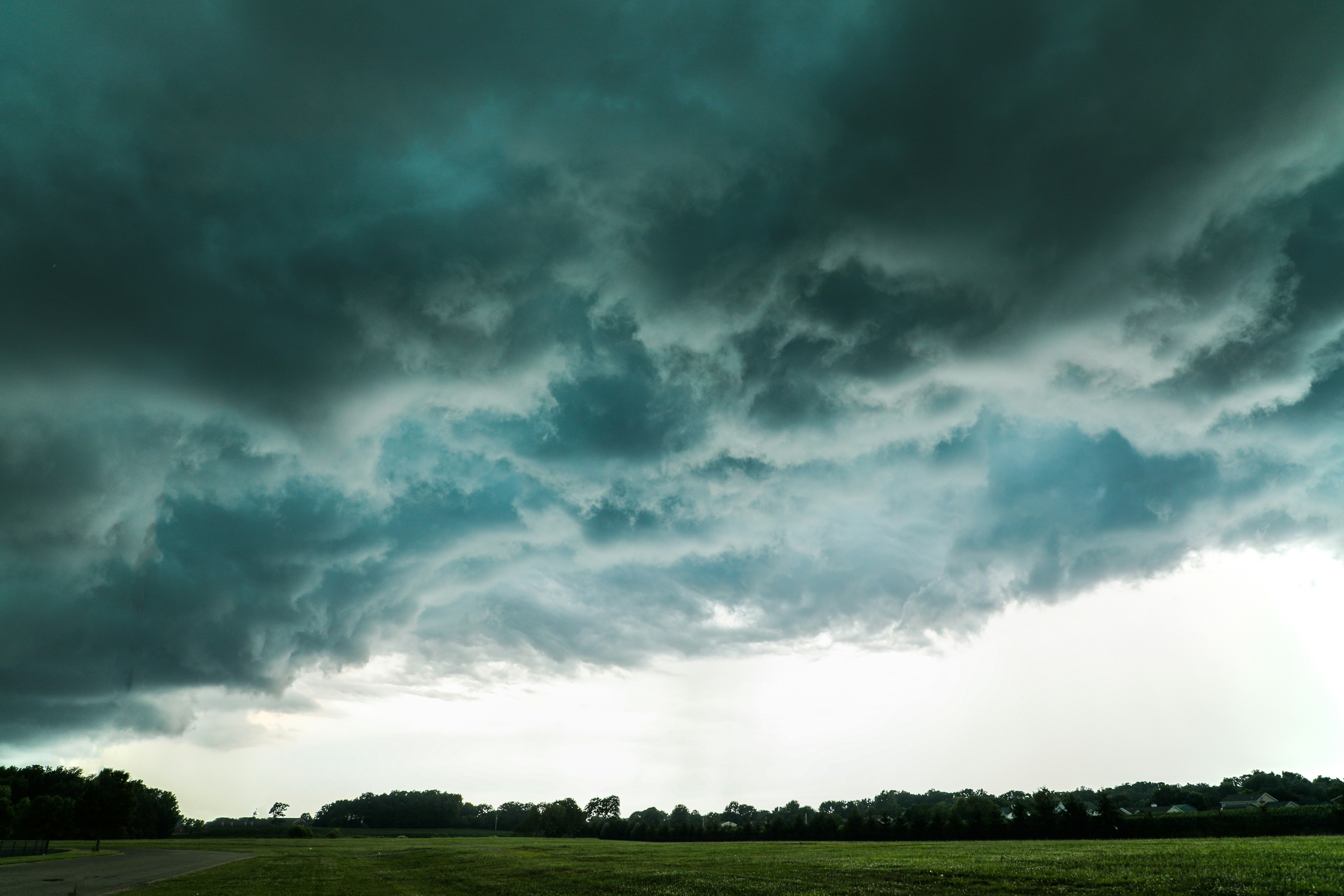 Storm Clouds Over Grassy Field