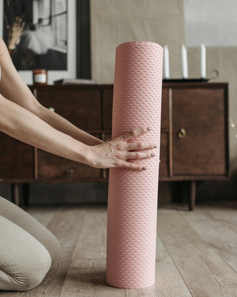 Woman Holding Pink Foam Roller At Home