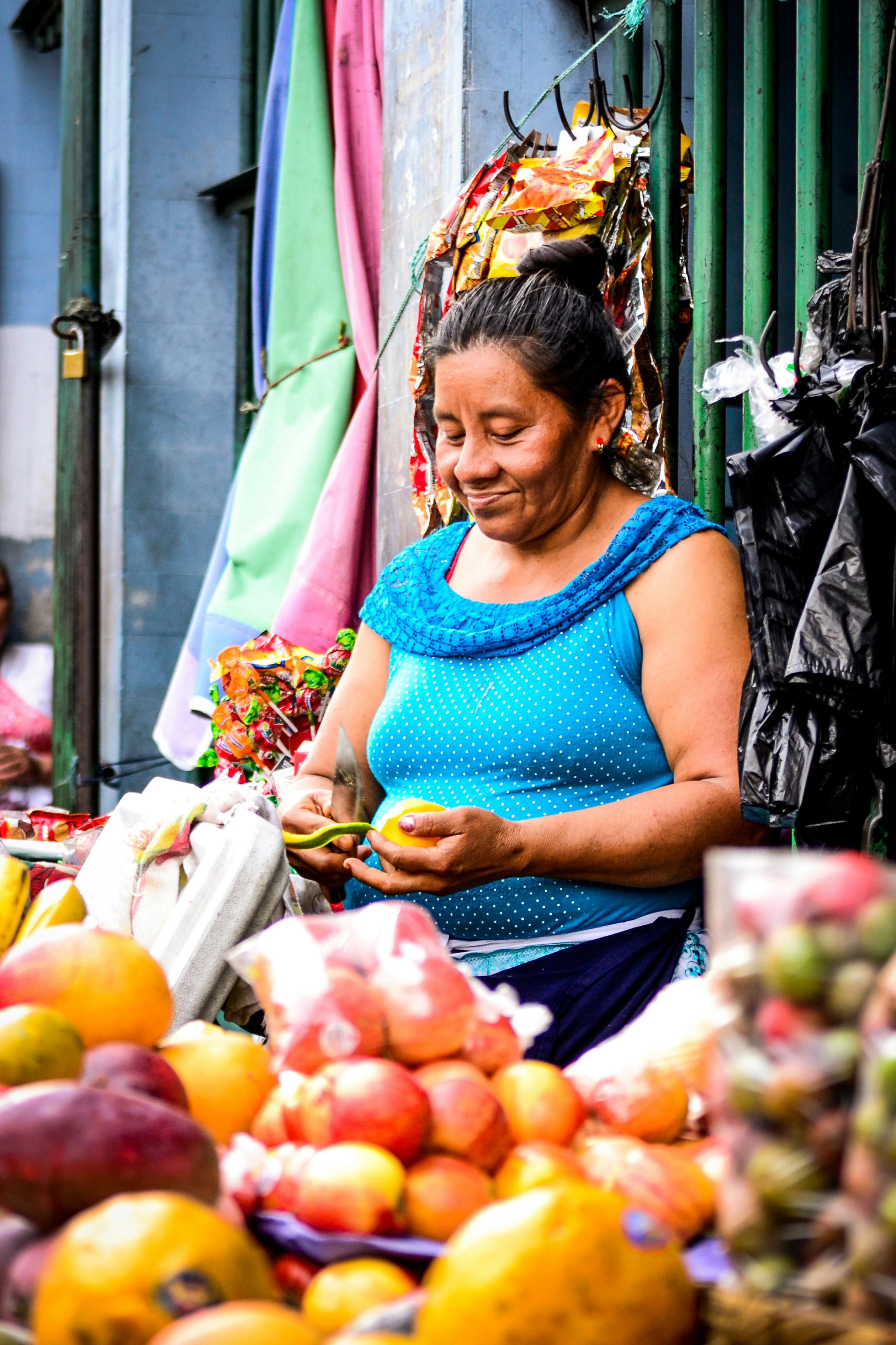 Fruit Vendor Prepares Orange at Street Market