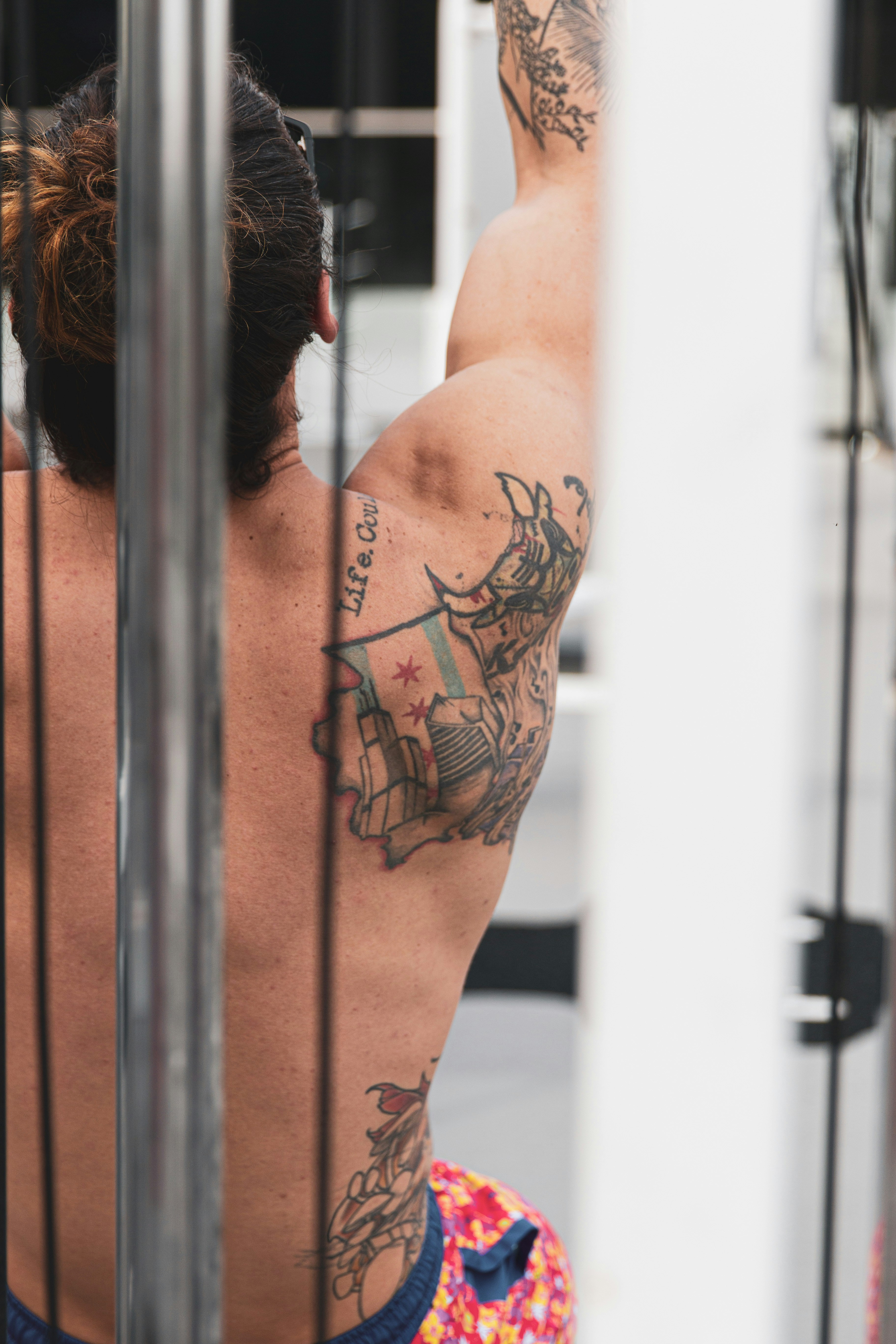 Tattooed Man Working Out in Gym