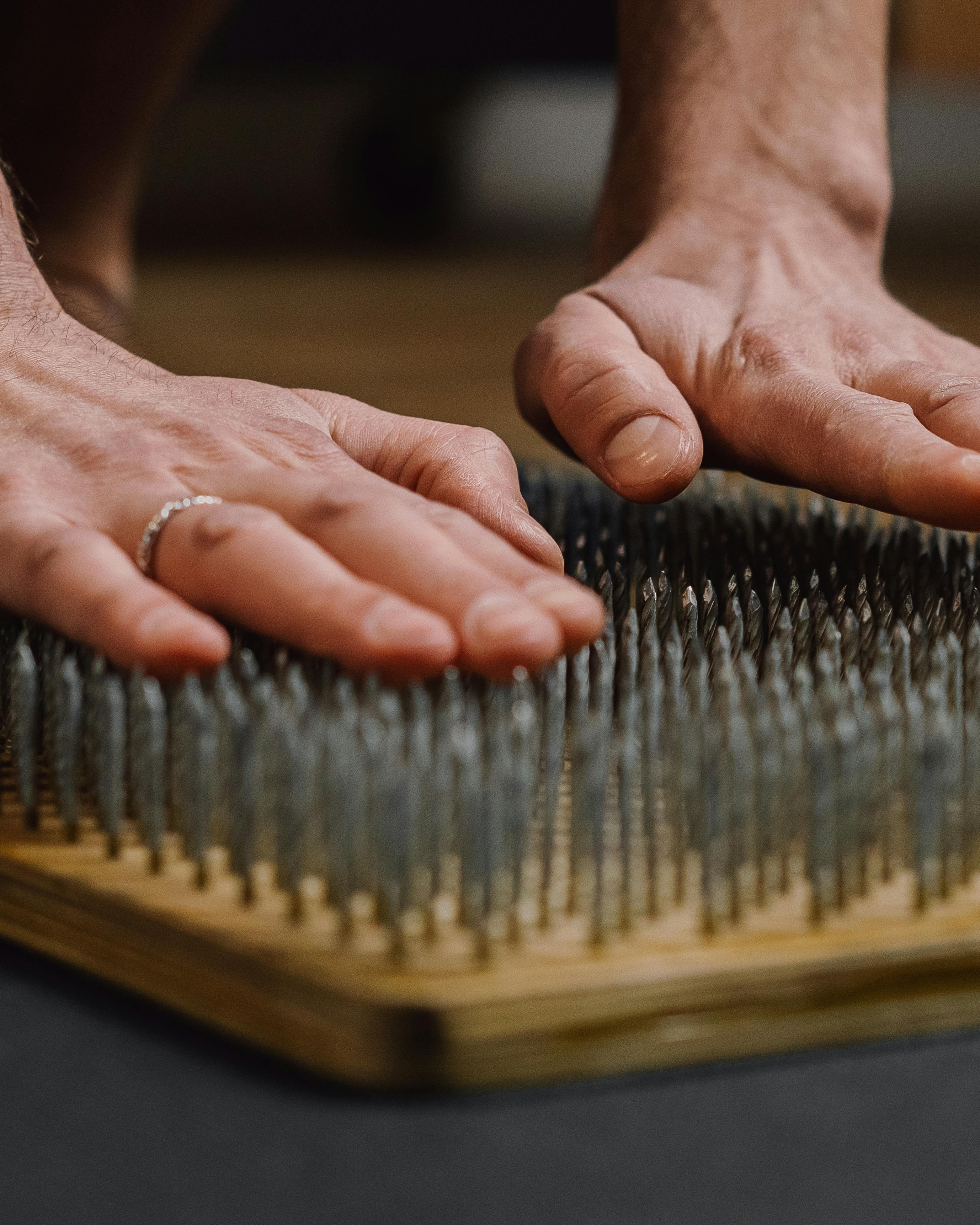Hands Resting on Sadhu Nail Board