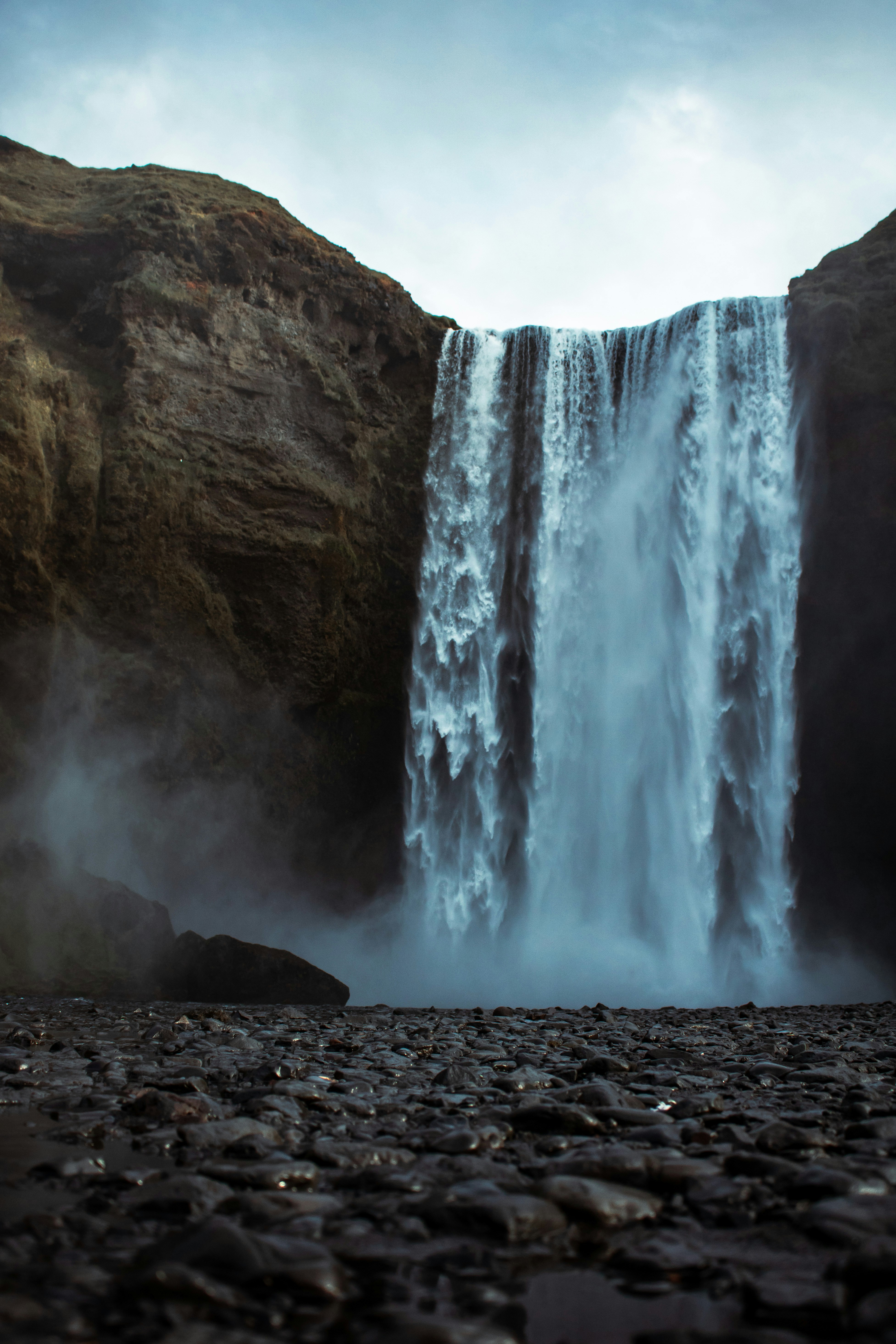 Large Waterfall Between Rocky Cliffs