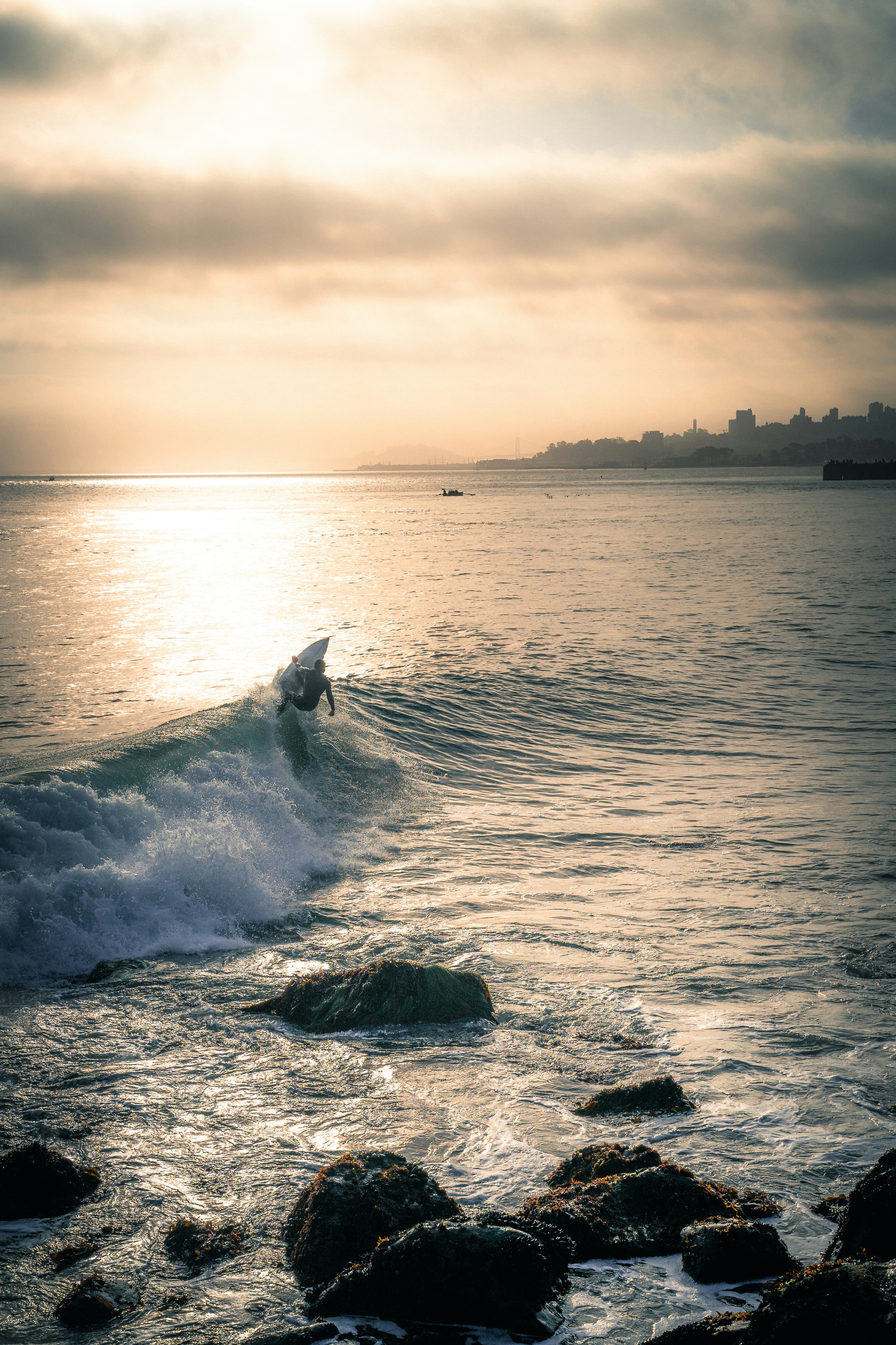 Surfer Riding Wave at Coastal Sunset