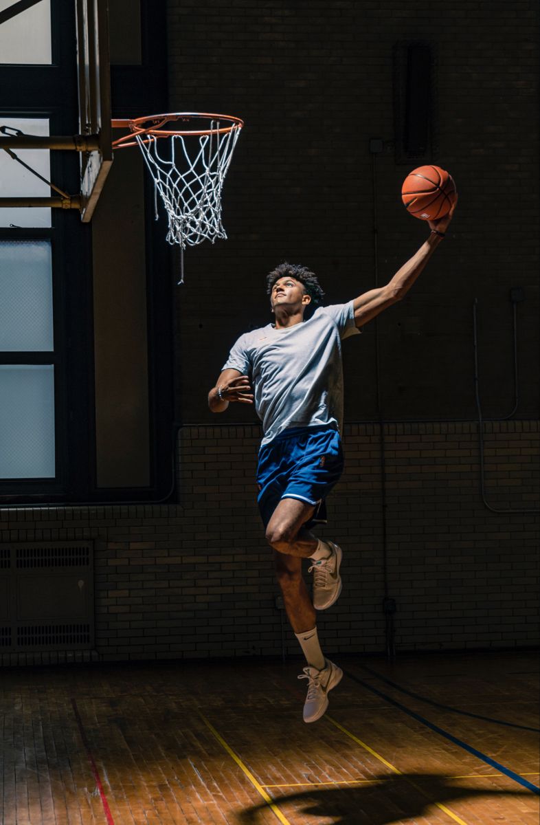Basketball Player Dunking in Indoor Gym