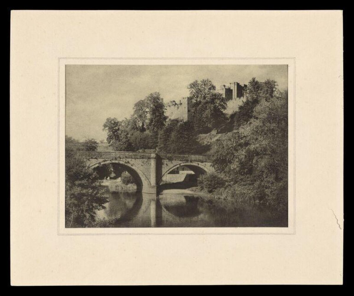 Castle Ruins Over River with Stone Bridge