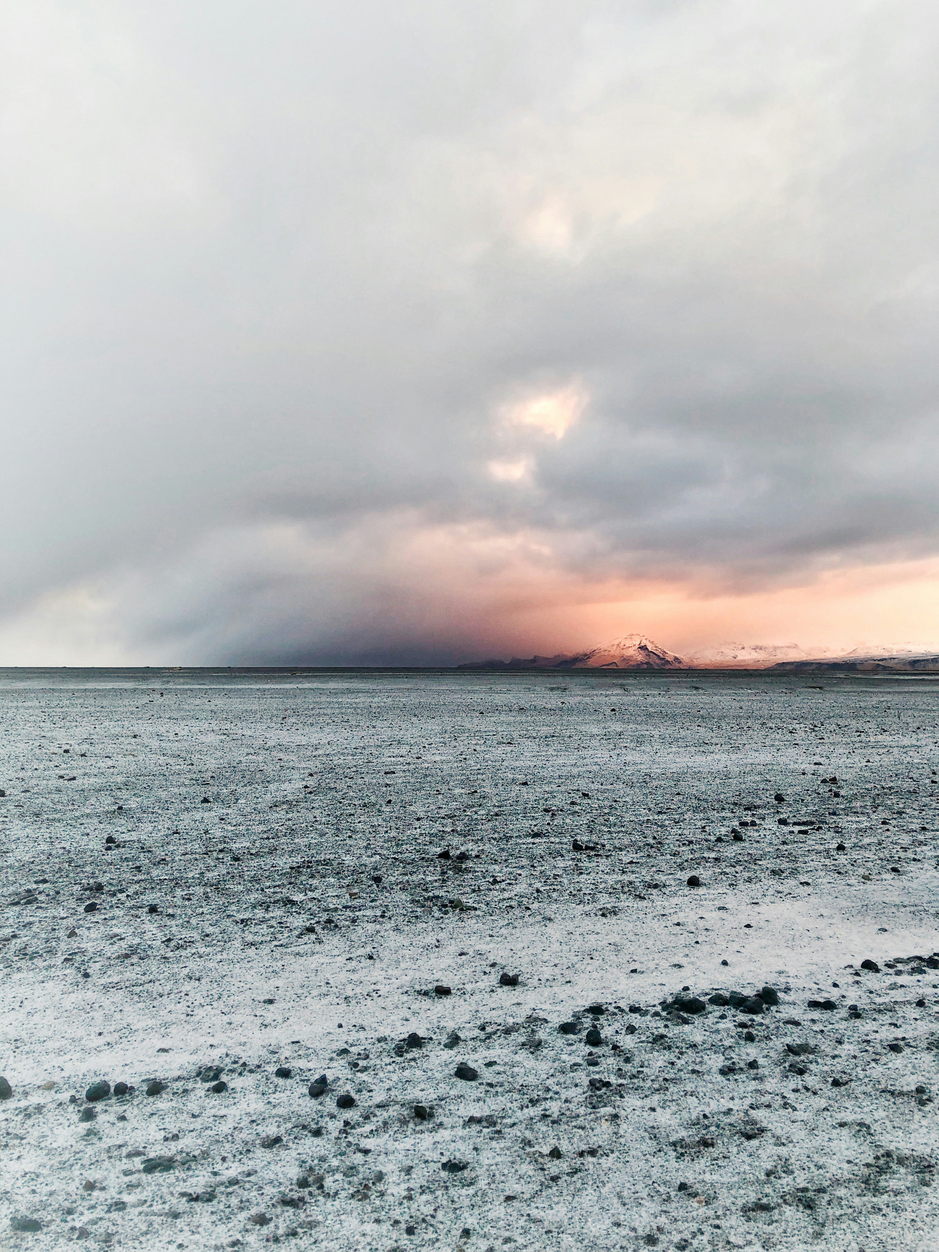 Barren Plain and Distant Snow Mountain at Dusk