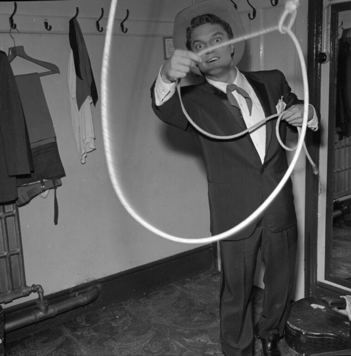 Man Twirling Lasso In Dressing Room