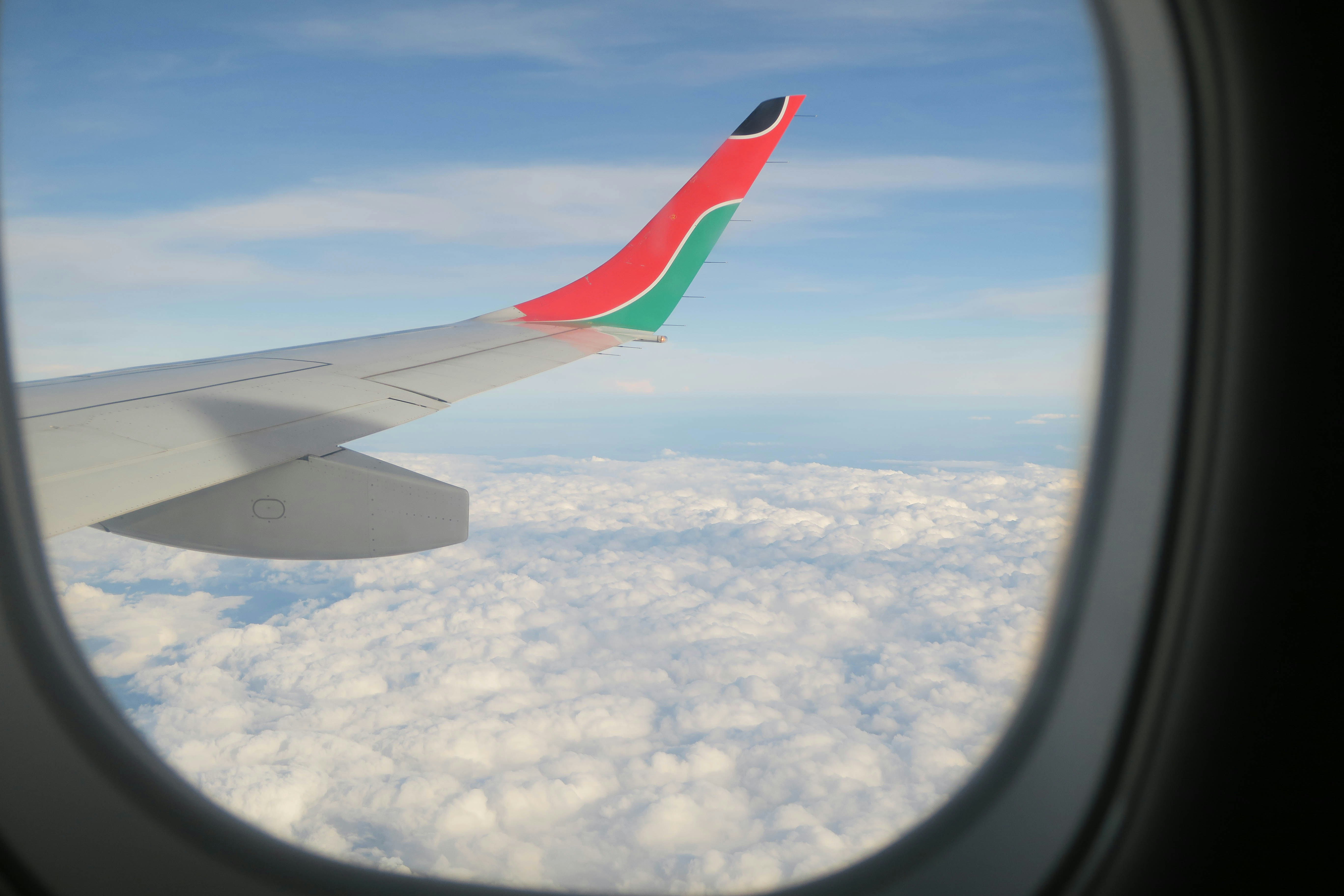 Airplane Wing View Above Clouds