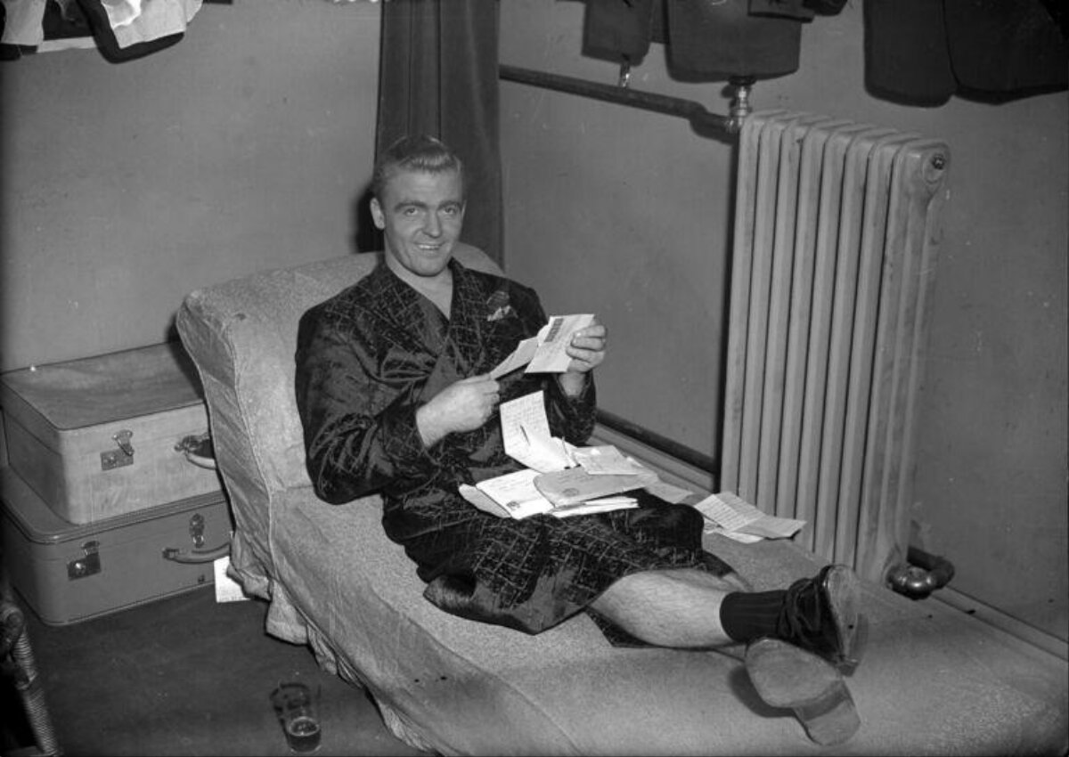 Man Reading Mail In Dressing Room