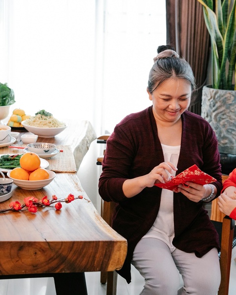 Woman Opening Lunar New Year Red Envelope