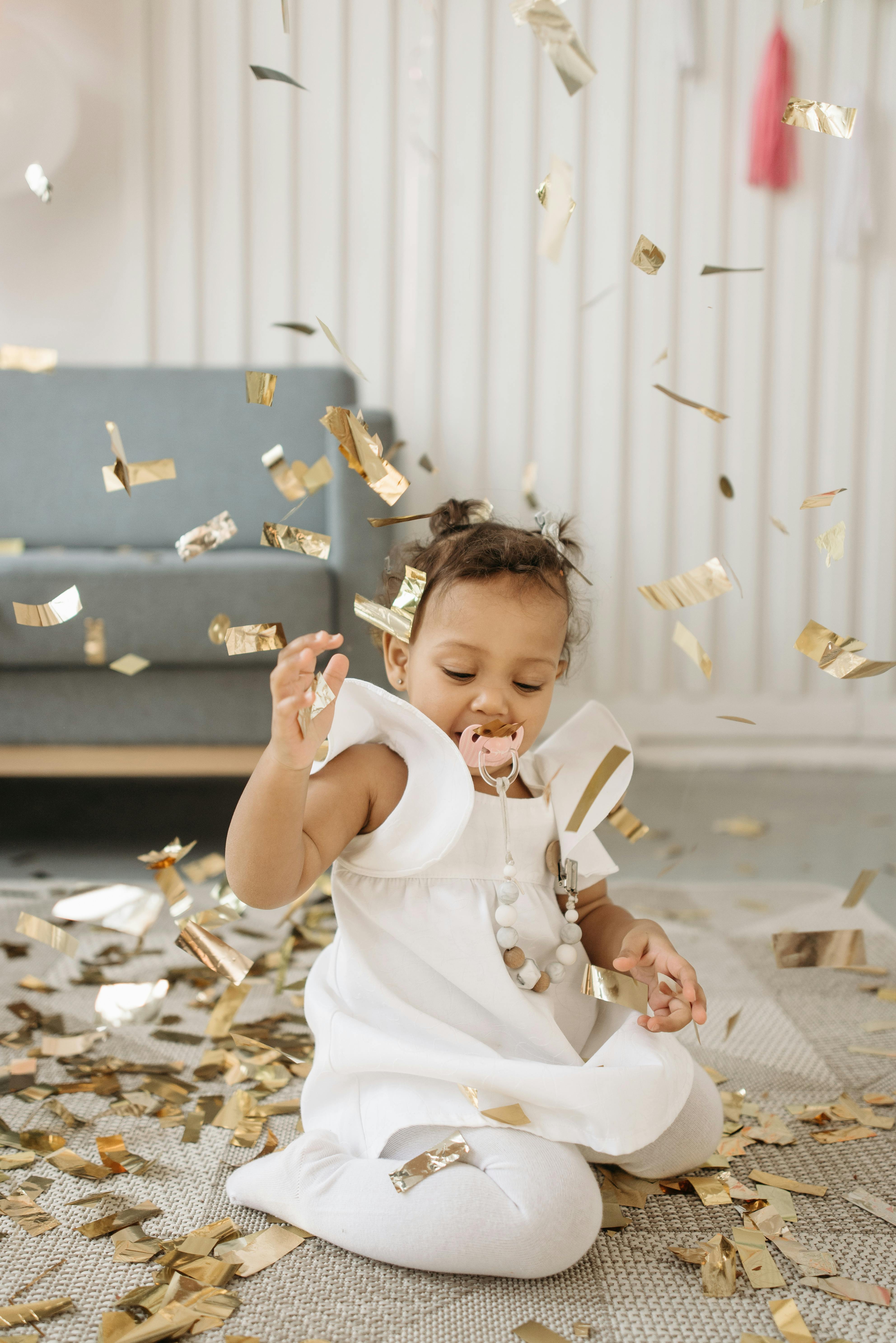 Baby Girl Playing With Gold Confetti