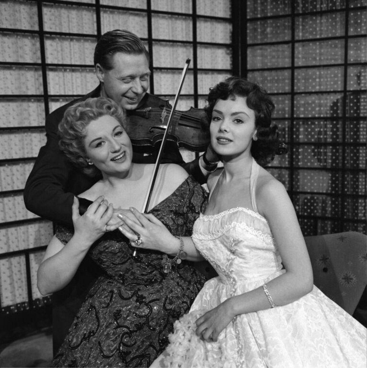 Man with Violin and Two Seated Women