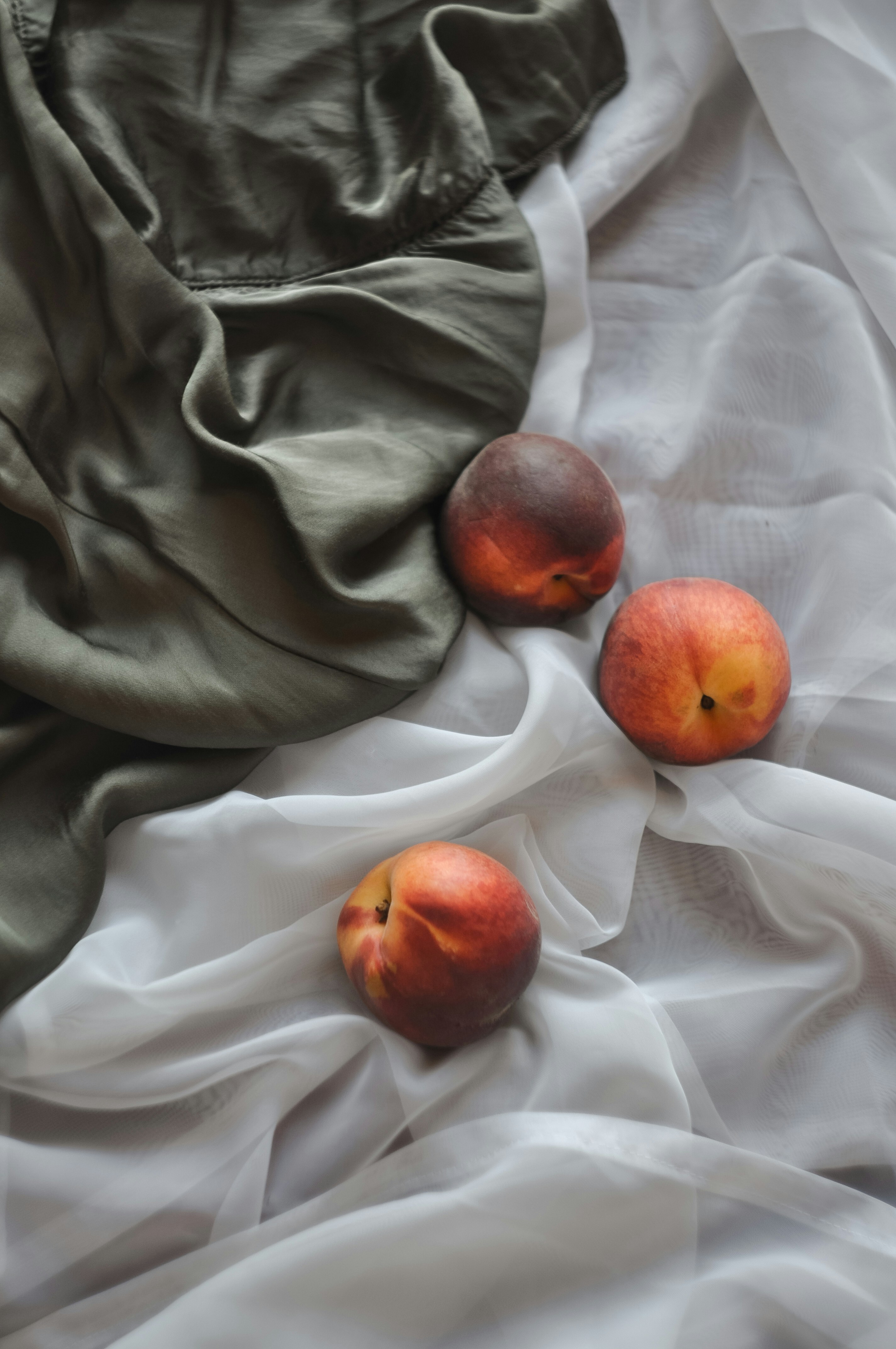 Three Peaches On Soft Fabrics