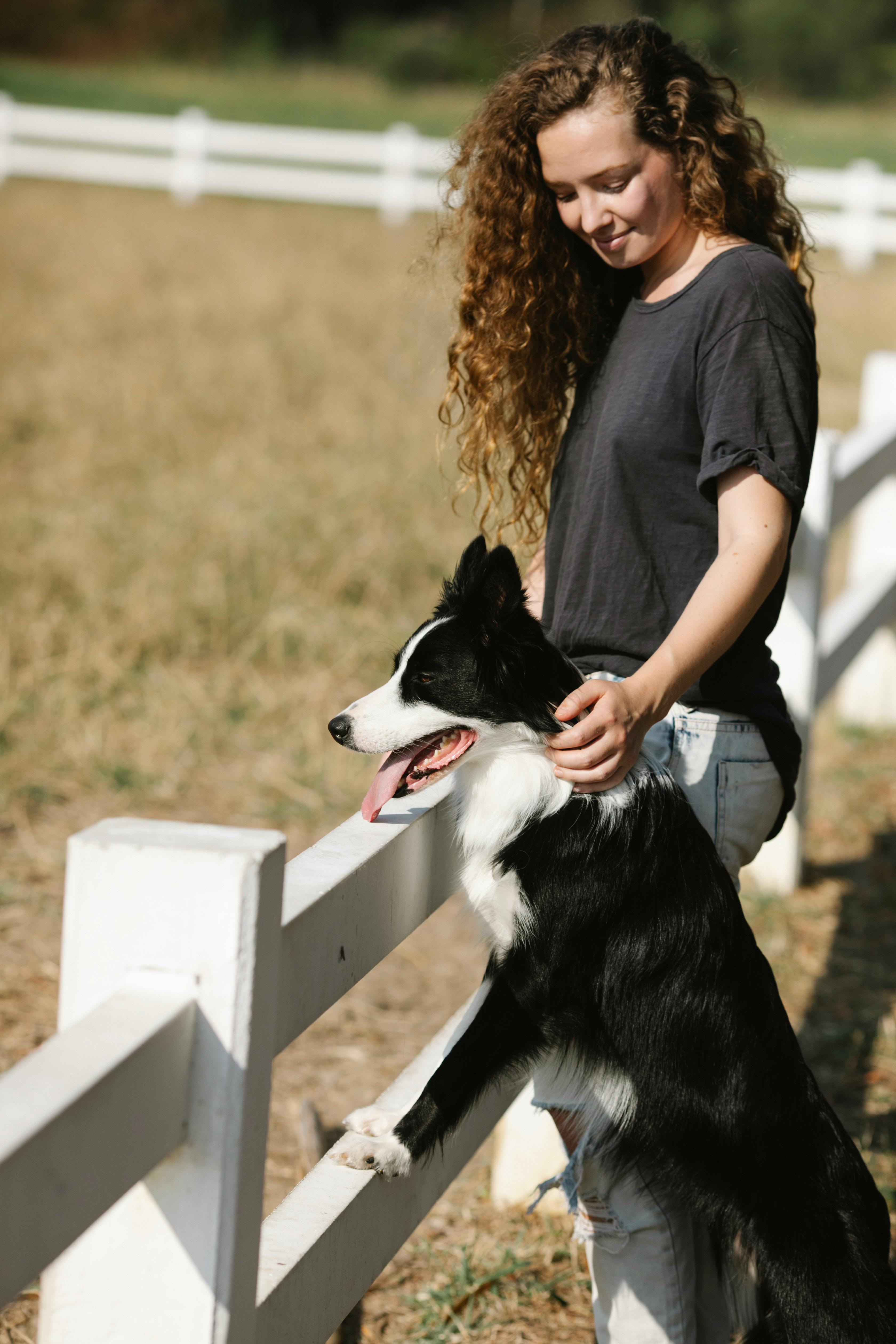 Woman and Dog By White Farm Fence