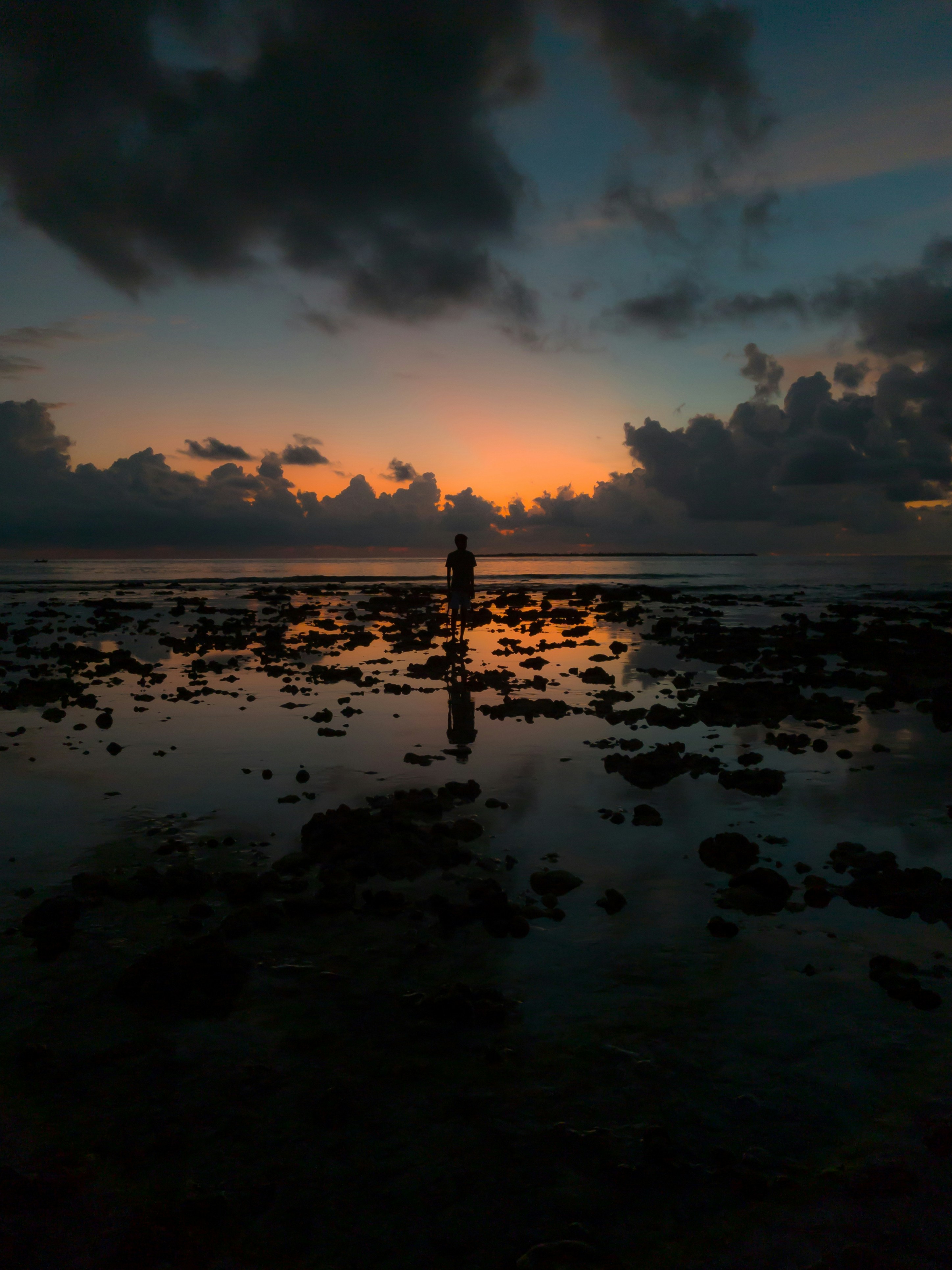 Low Tide Sunset Beach with Man Silhouette