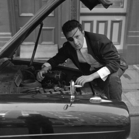 Man with Eyepatch Checking Car Engine