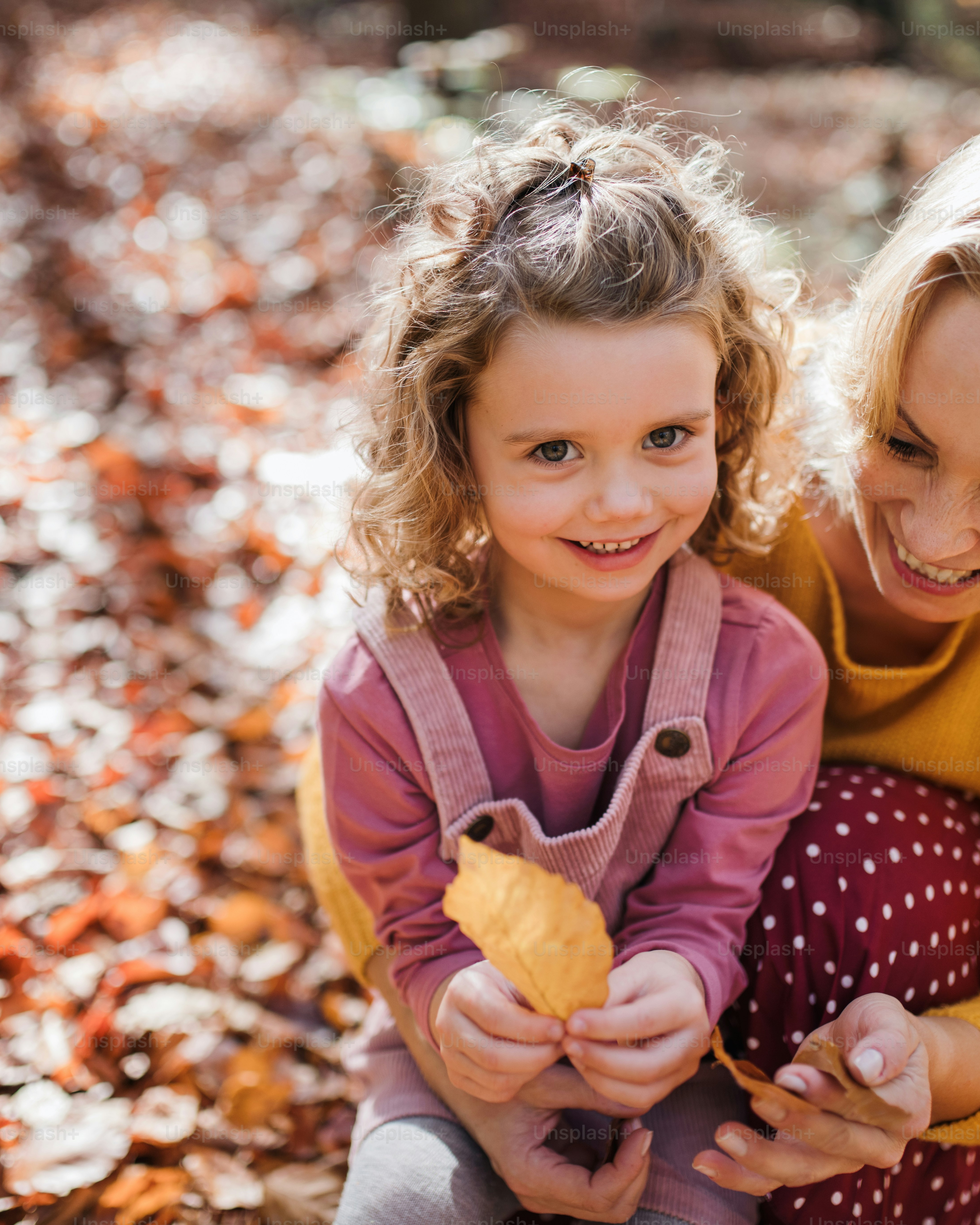 Mother and Daughter Among Autumn Leaves