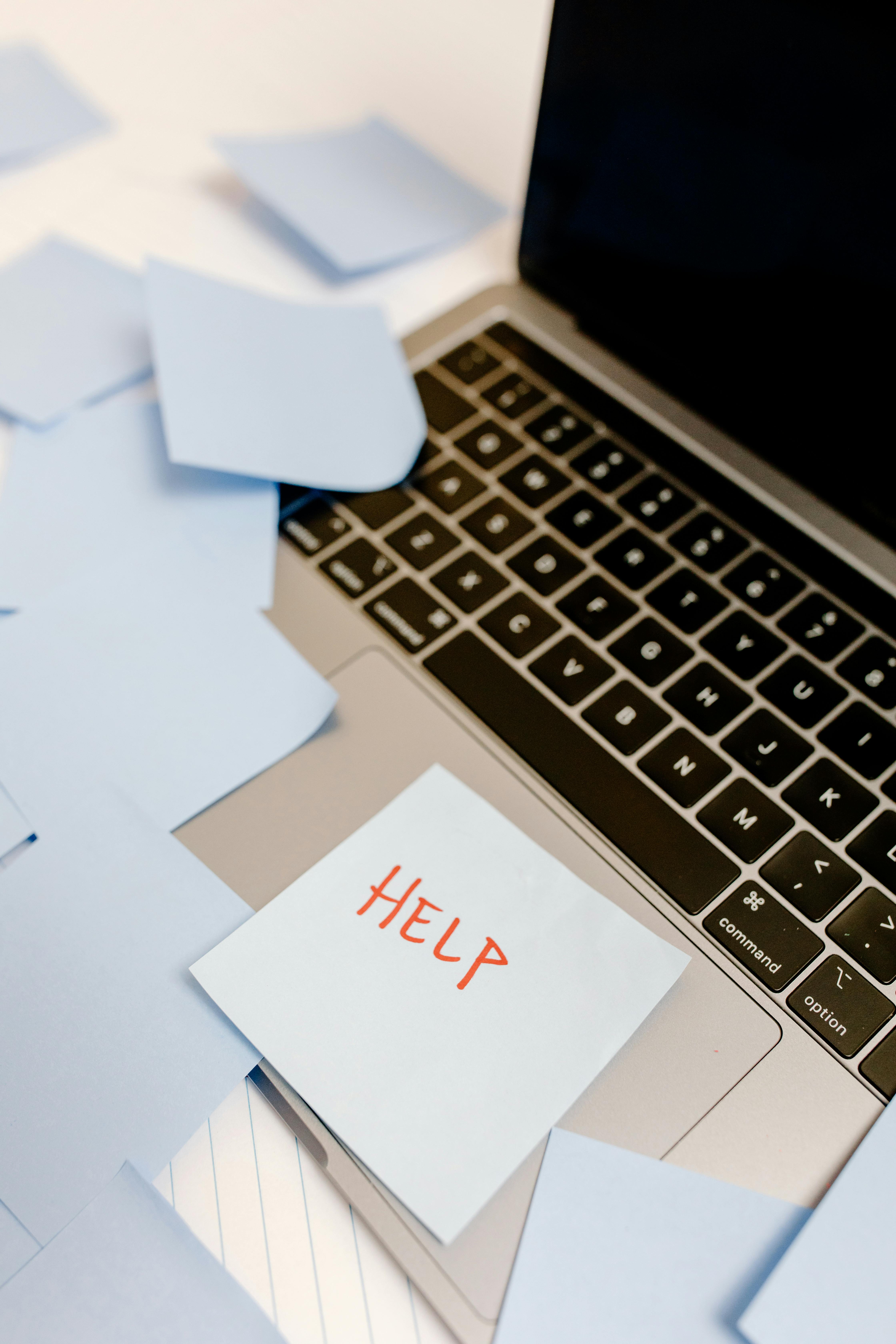 Sticky Note With HELP On Laptop