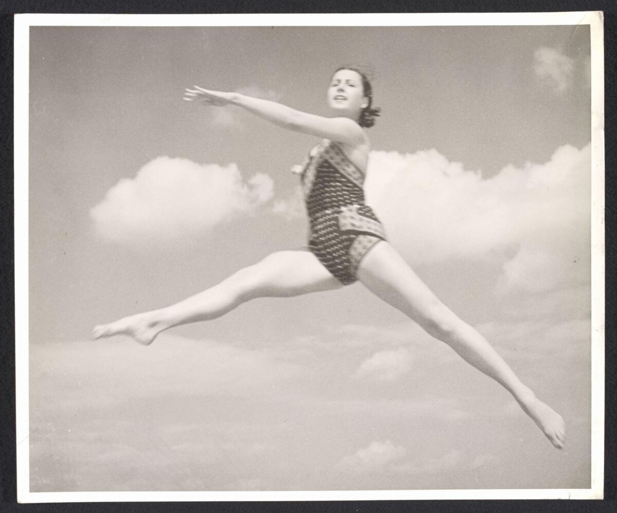Woman Doing Split Leap Against Sky