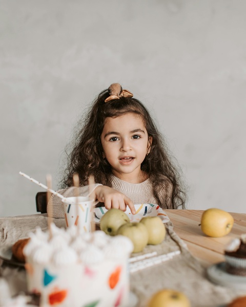 Little Girl At Birthday Snack Table