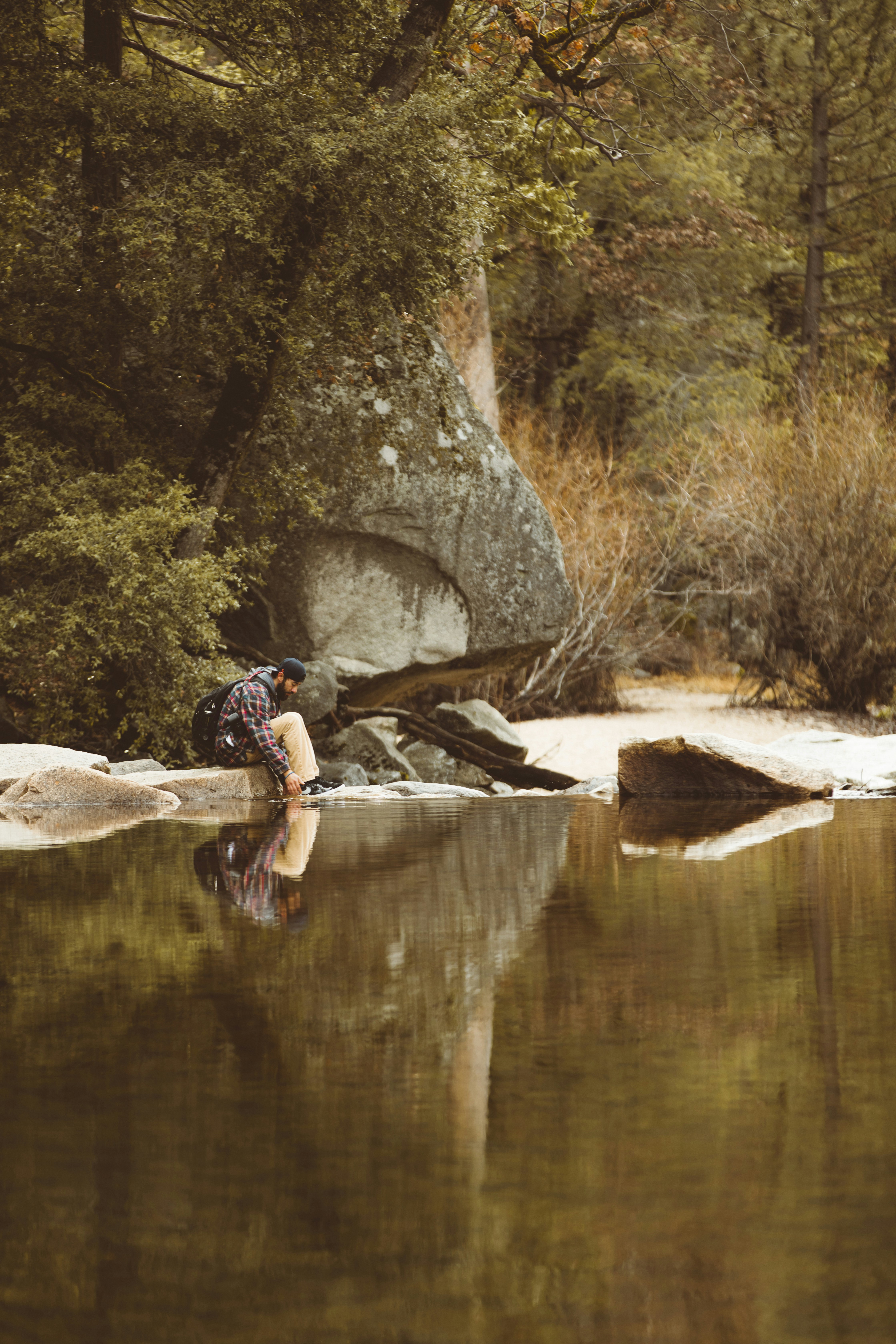 Hiker Resting By Calm River
