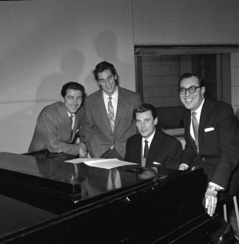 Four Men Gathered Around a Grand Piano