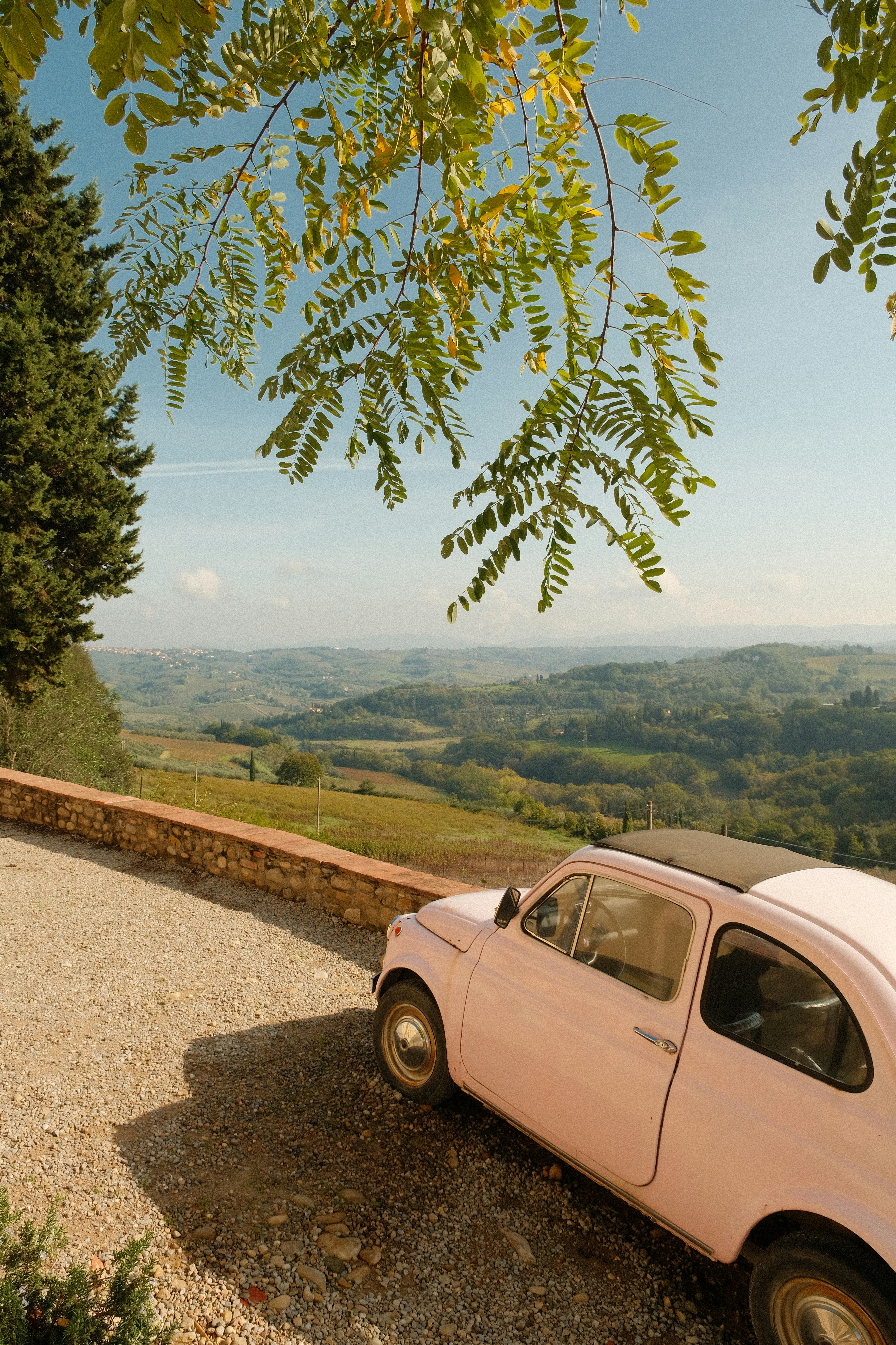 Pink Vintage Car Overlooking Countryside Hills