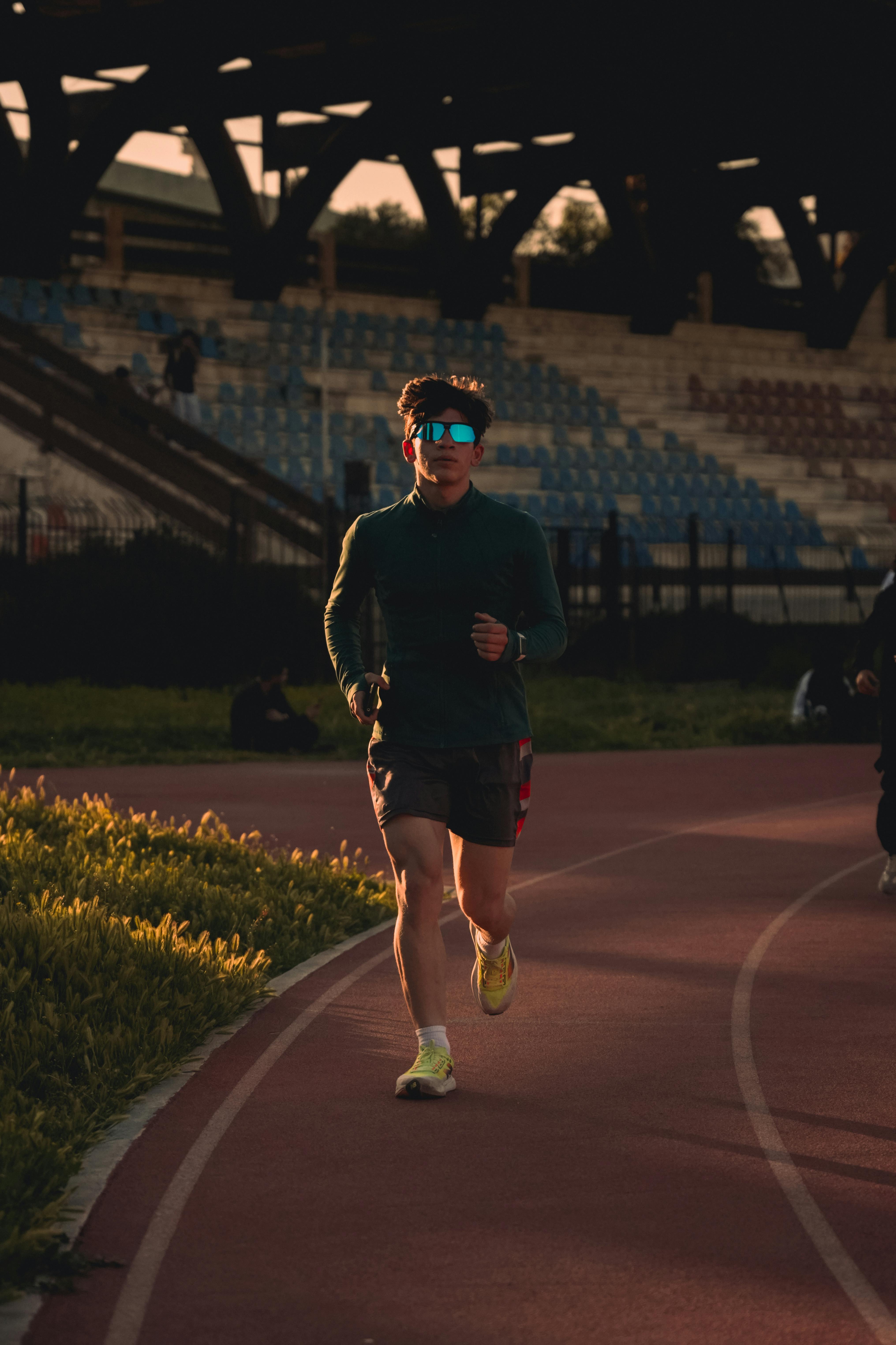 Man Running on Stadium Track