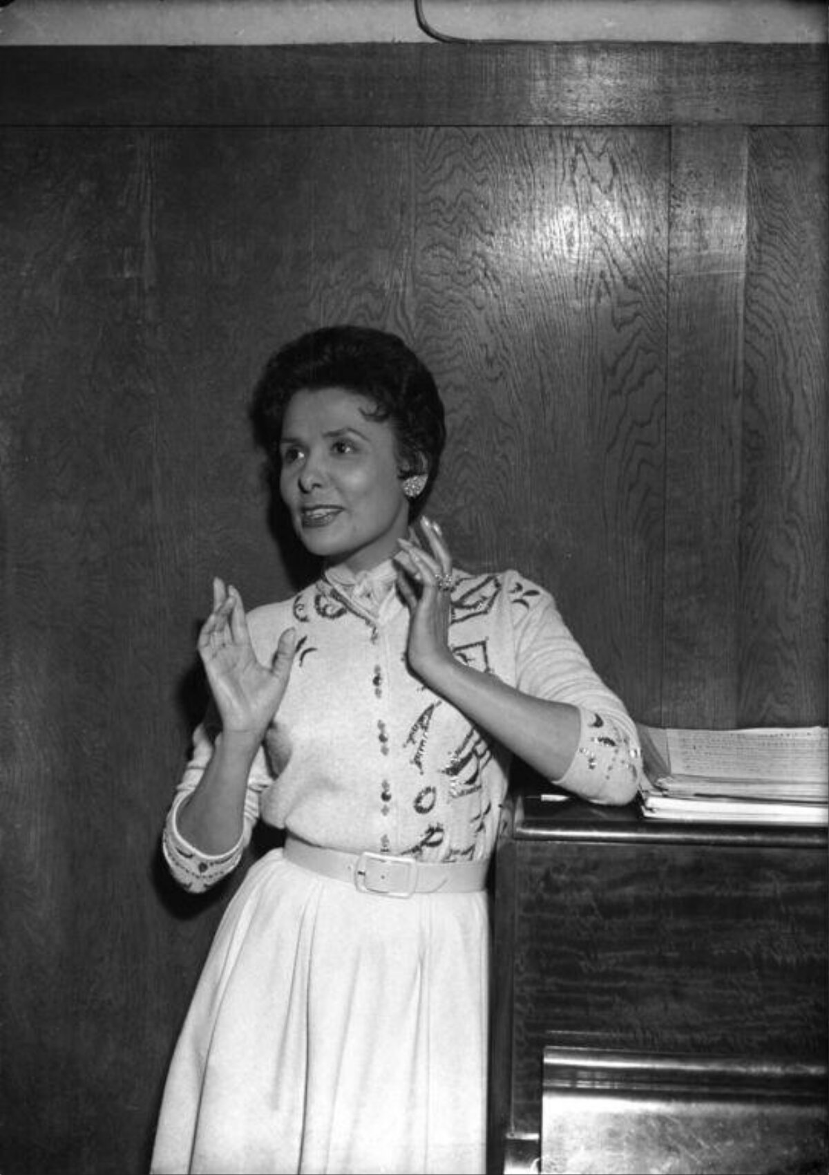 Female Singer Leaning On Piano