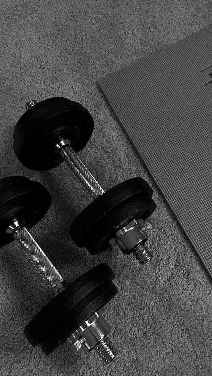 Two Adjustable Dumbbells By Yoga Mat