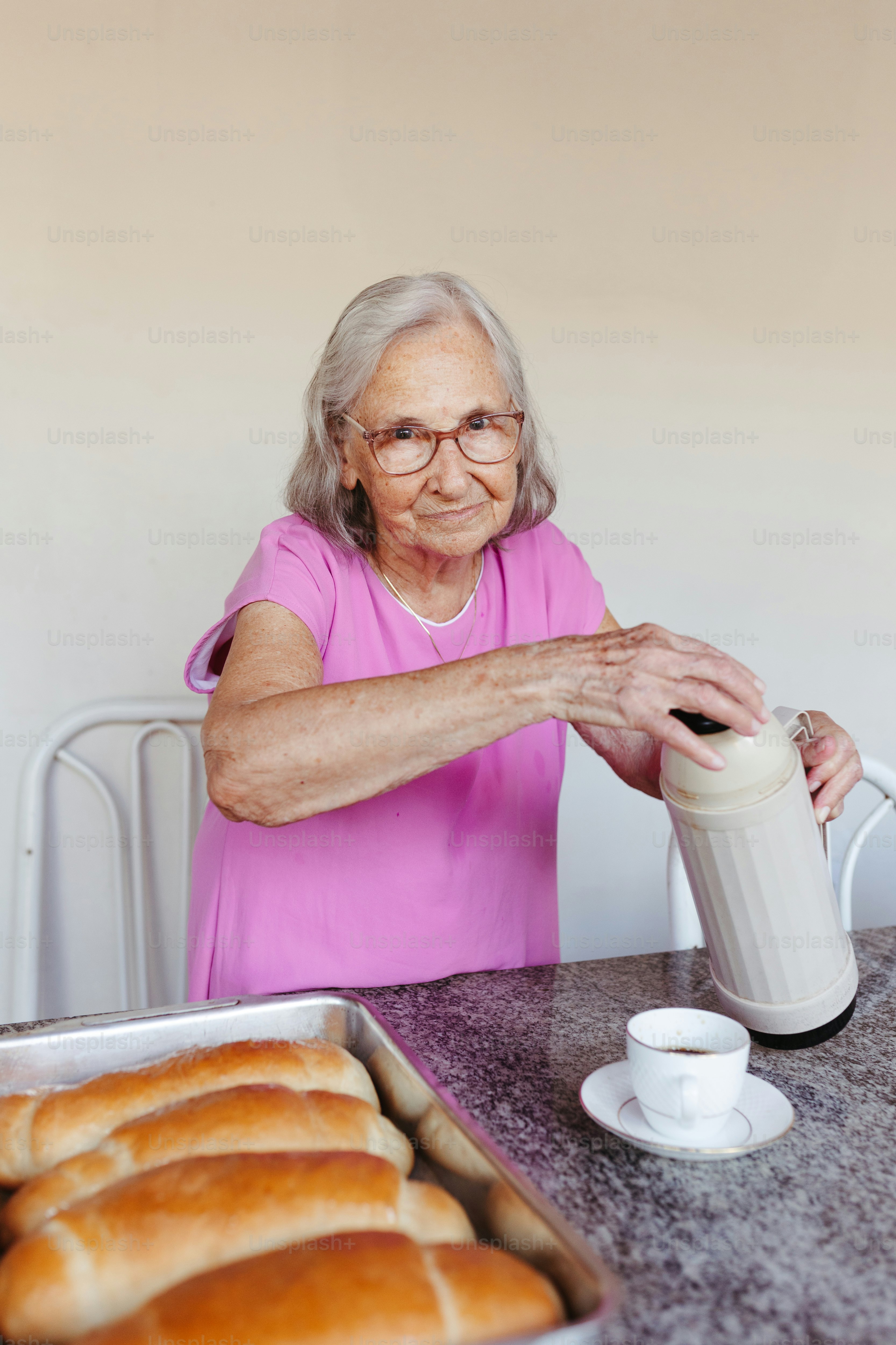 Senior Woman Preparing Drink With Homemade Bread