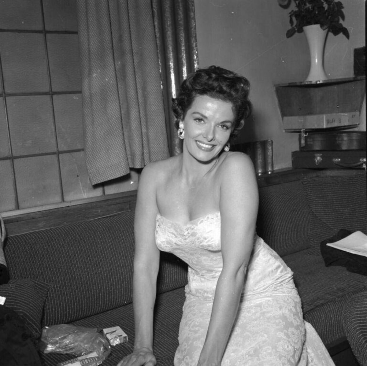 Smiling Actress in Strapless Gown on Sofa