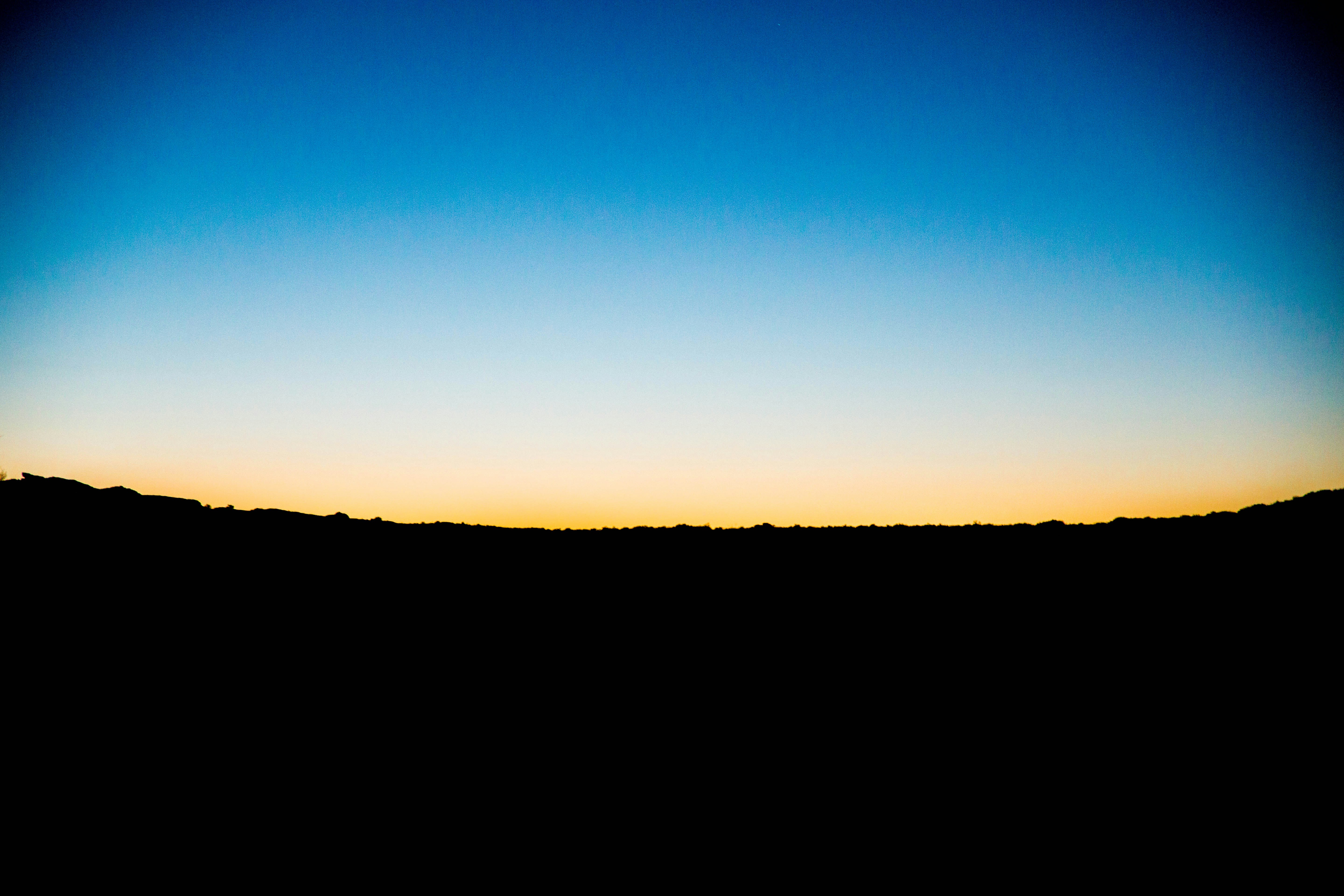 Twilight Sky Over Silhouetted Terrain