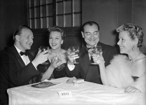 Four People Toasting at Formal Gathering