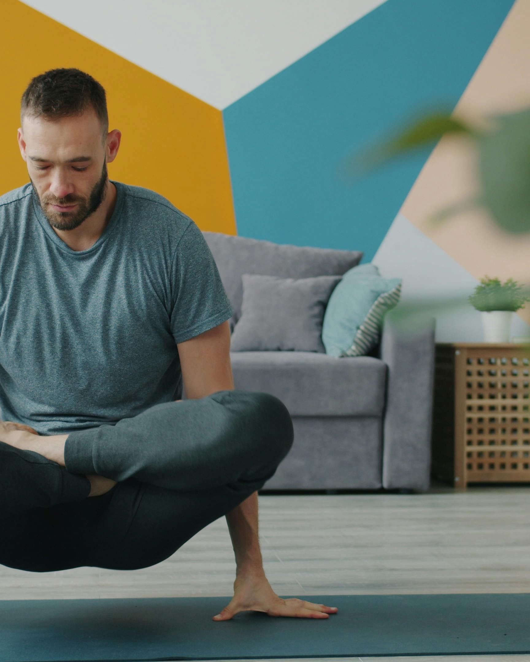 Man Practicing Yoga At Home
