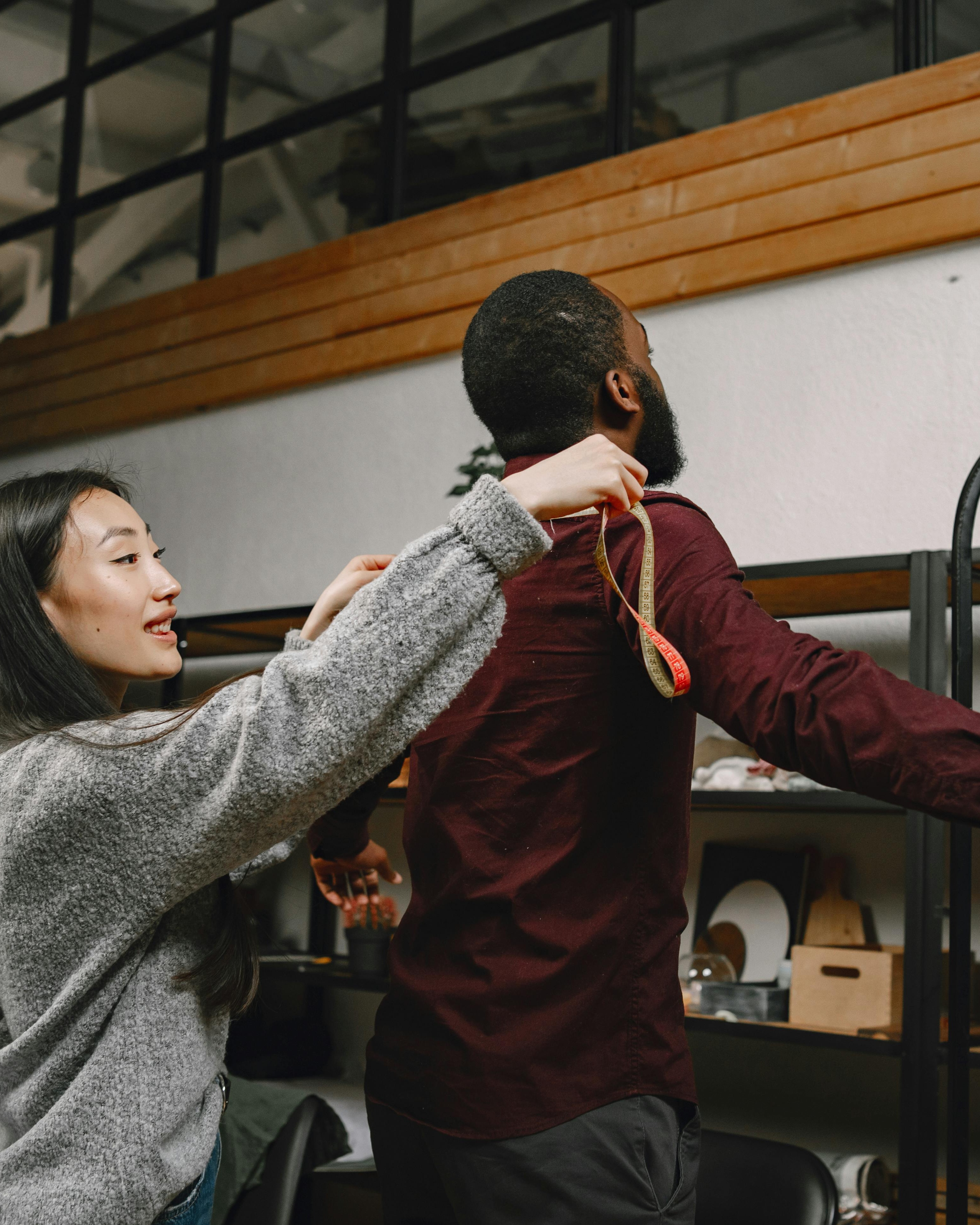 Woman Measuring Man for Clothing Fitting
