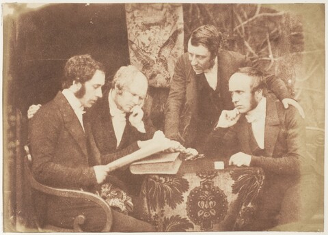 Four Victorian Gentlemen Studying a Document