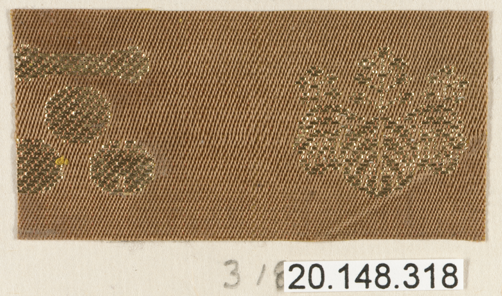 Woven Textile Swatch with Gold Crest Patterns