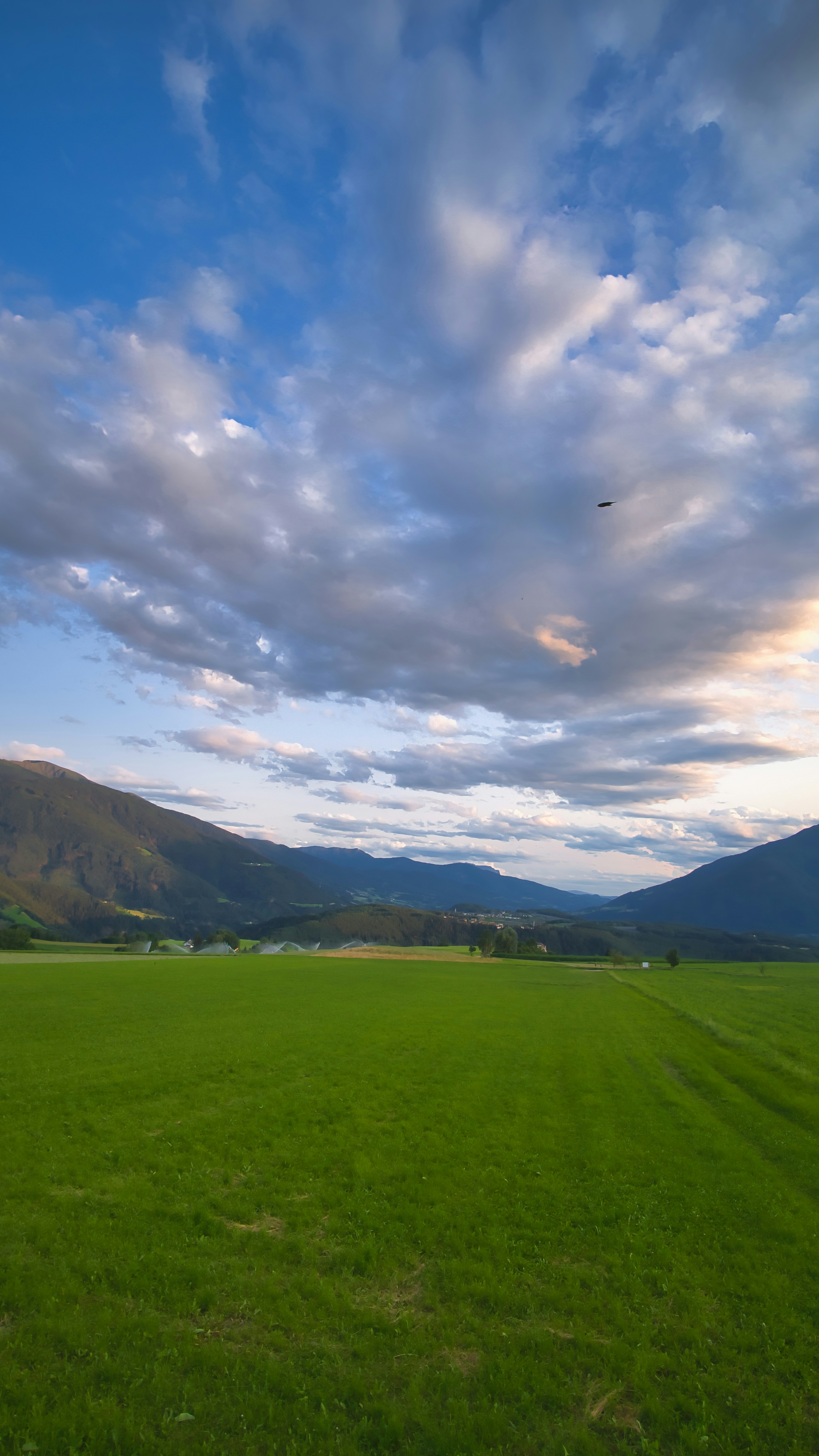 Valley Green Field Under Cloudy Sky