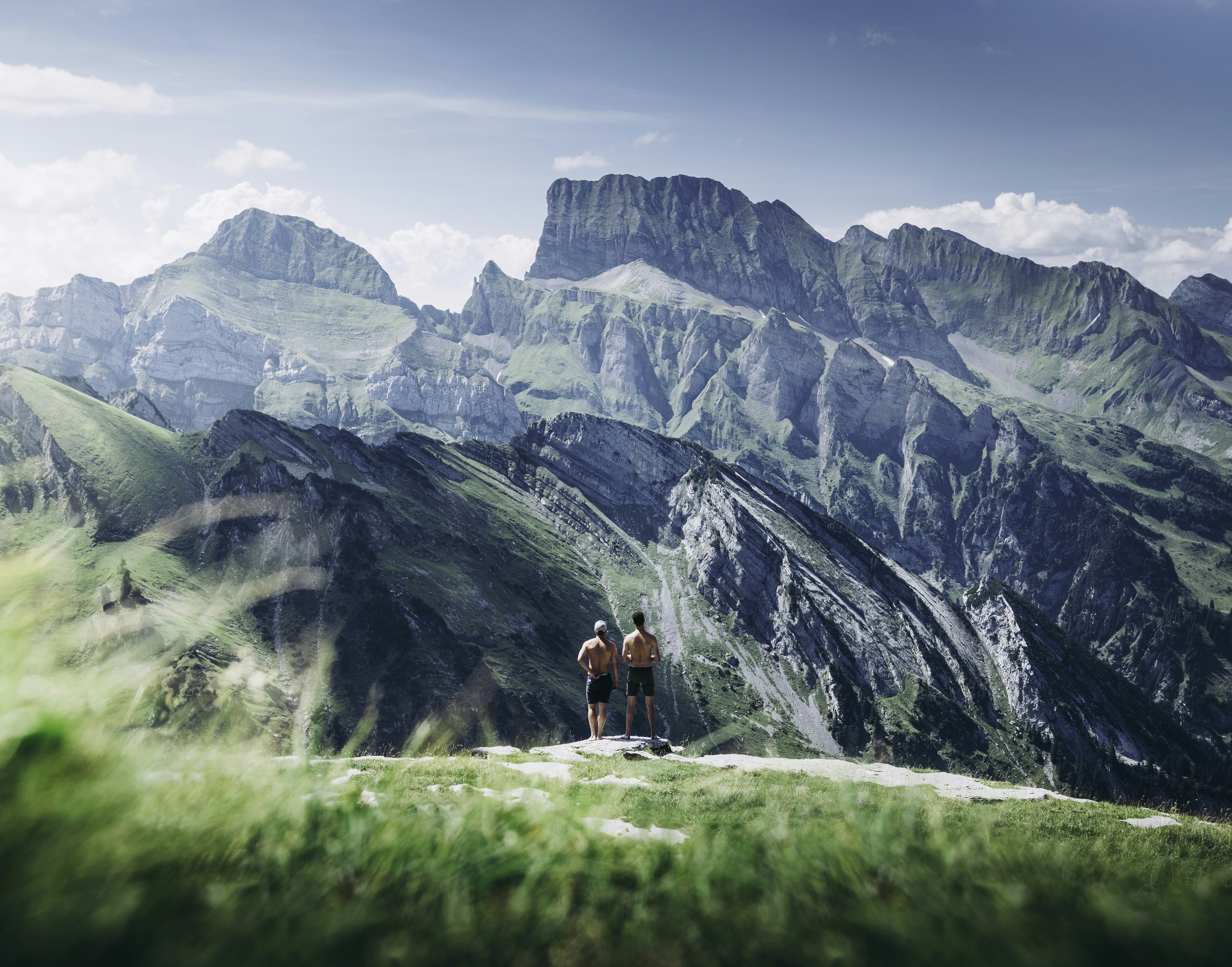 Two Hikers Overlooking Mountain Range