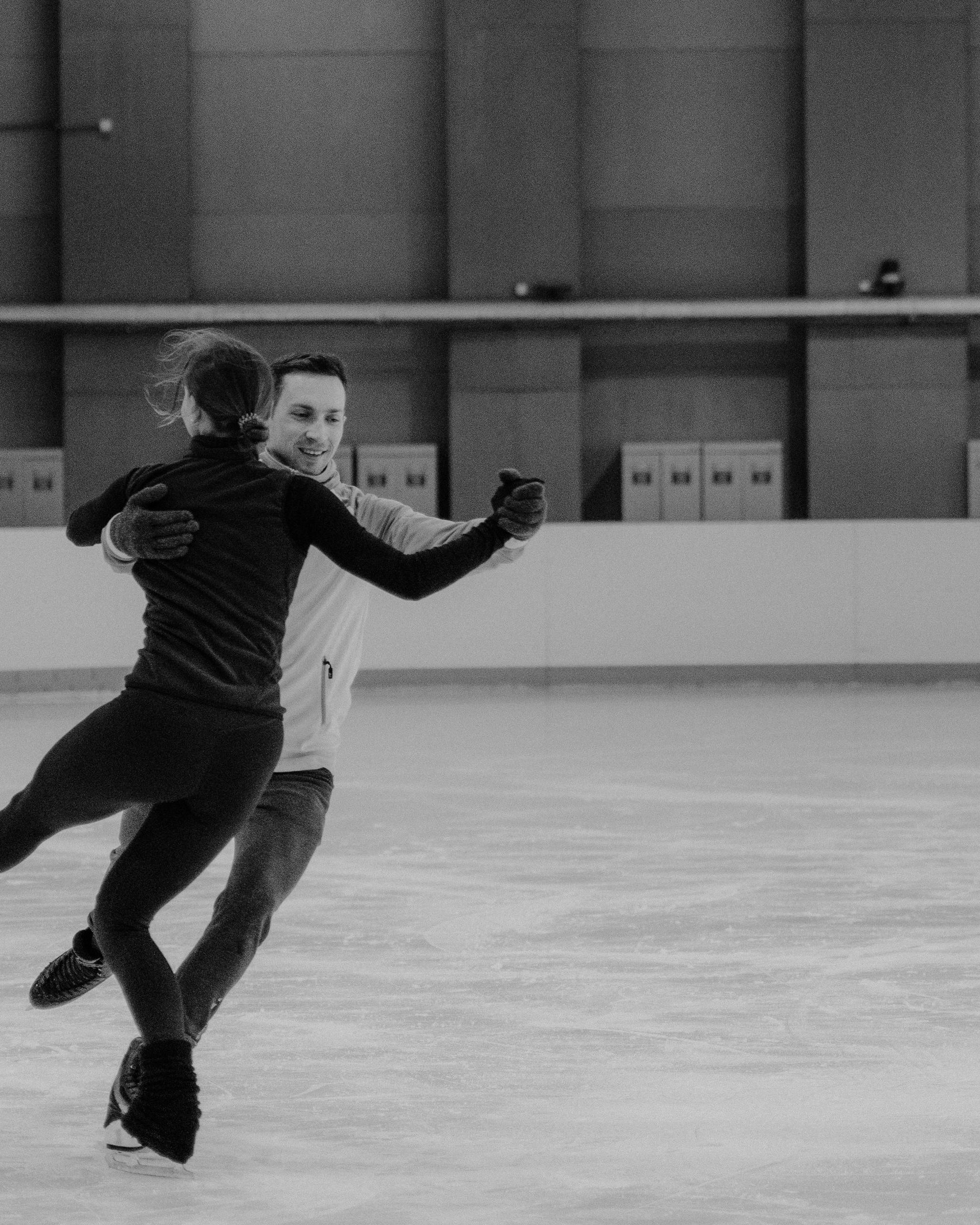 Pair Figure Skaters Practicing On Ice