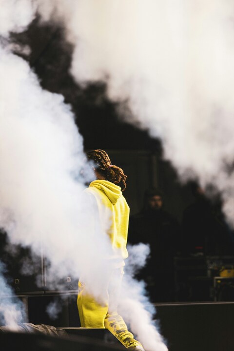 Performer in Yellow on Smoky Stage