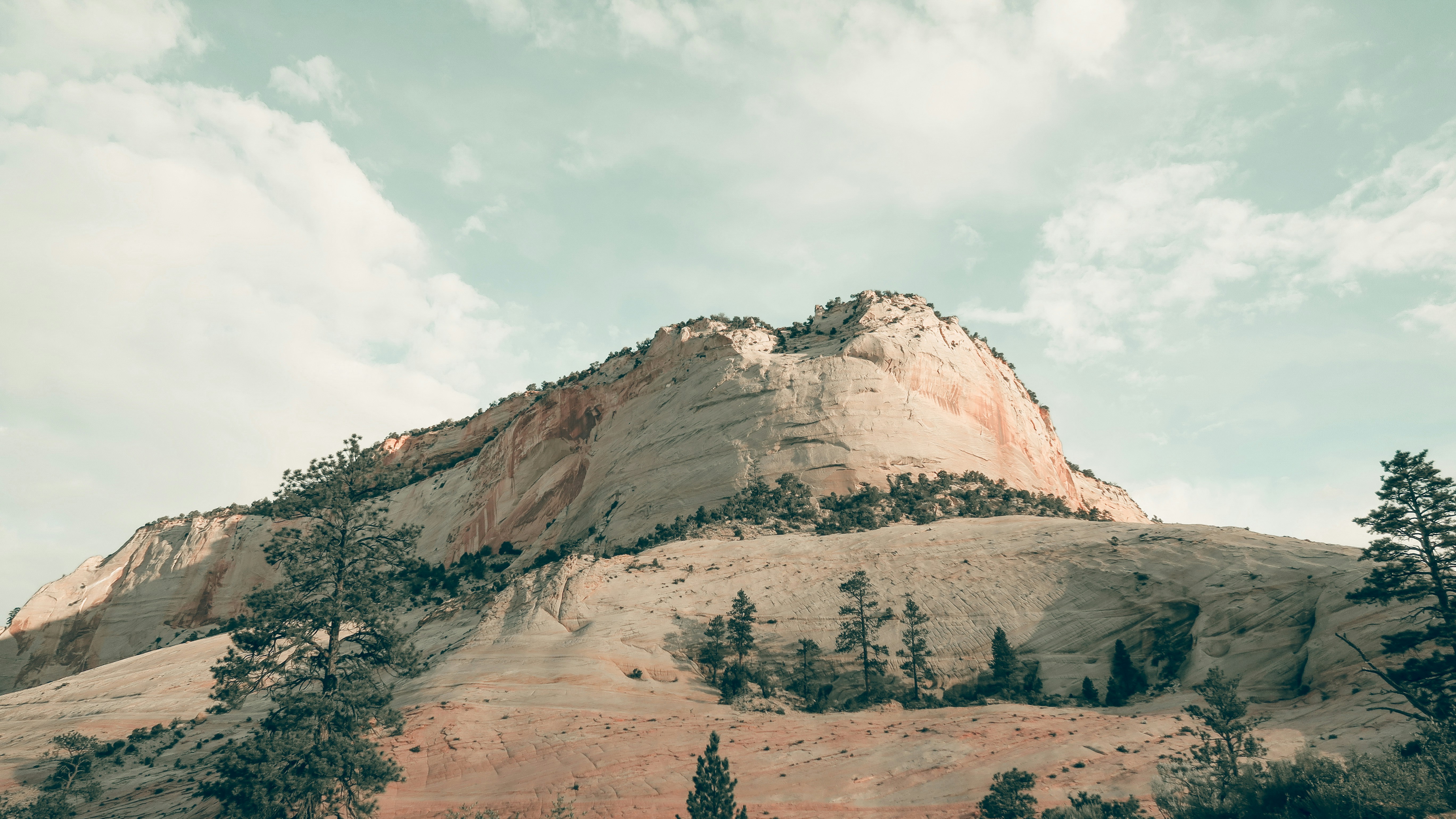 Sandstone Mountain Under Cloudy Sky